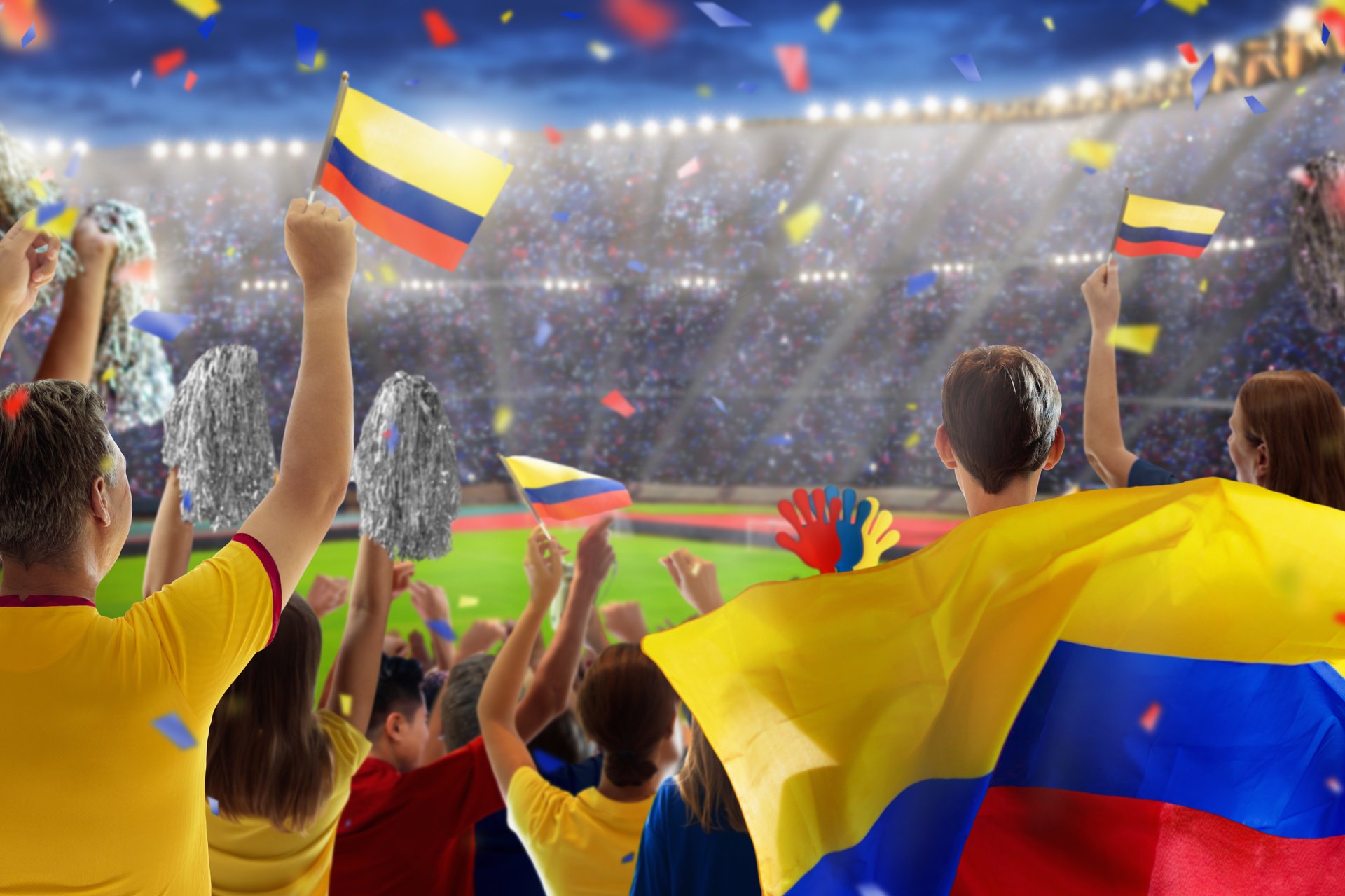 Colombia football supporter on stadium. Colombian fans on soccer pitch watching team play. Group of supporters with flag and national jersey cheering for Colombia. Championship game.