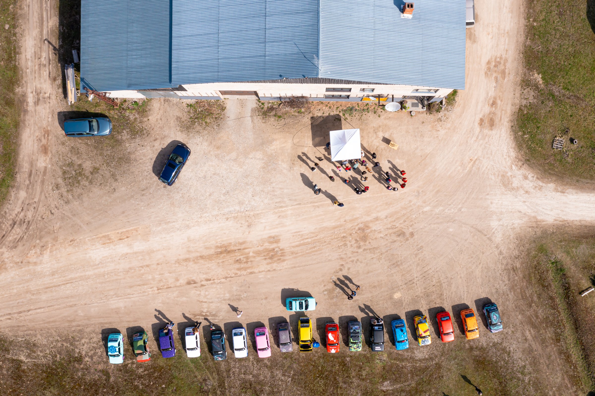 Madona, Latvia - May 02, 2021: row of colorful stylish vintage Fiat 126 PanCars rental cars, PanCars is a stylish compact car rental for team building , fun races and individual events, aerial drone view