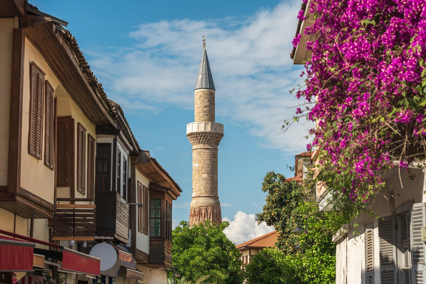 Sehzade Korkut Mosque or Kesik Minaret, seen among the historical houses in the streets of Antalya Old Town