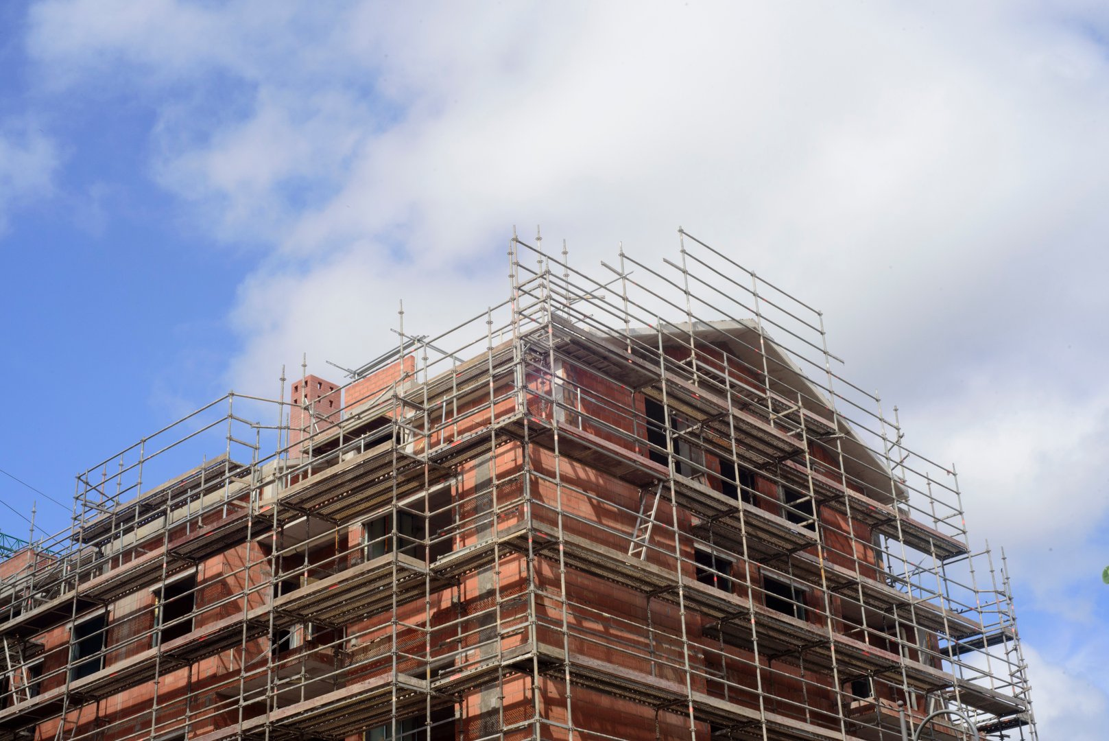 Scaffolded house building and sky