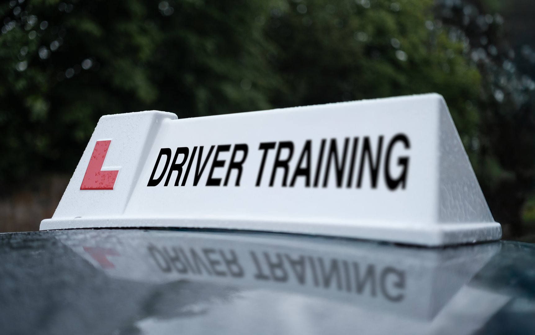 A Driver Training Sign On The Top Of A Car In The UK
