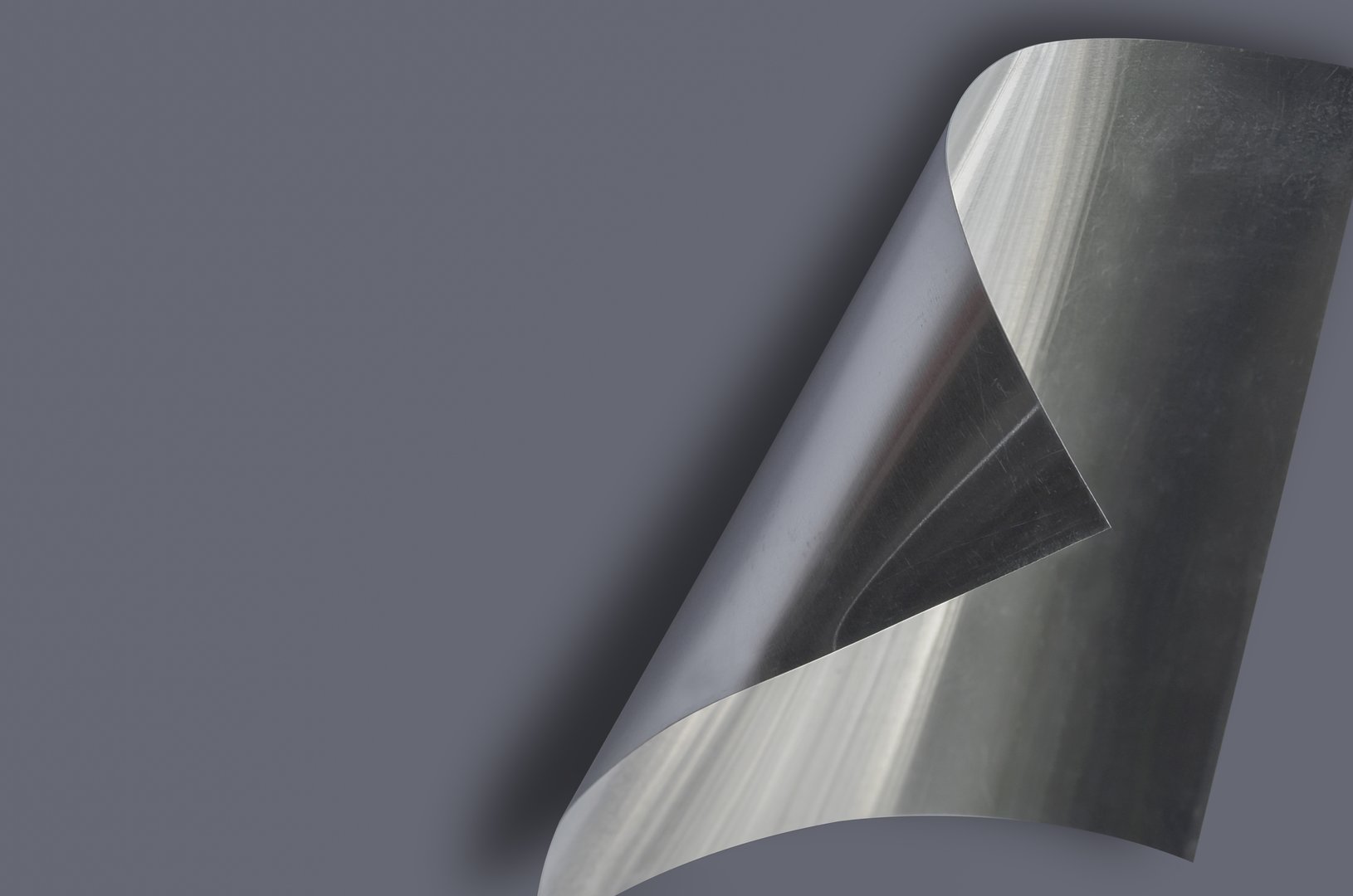 one sheet of thin silver aluminum with copy space for text. lightweight metal material with curved fold effect