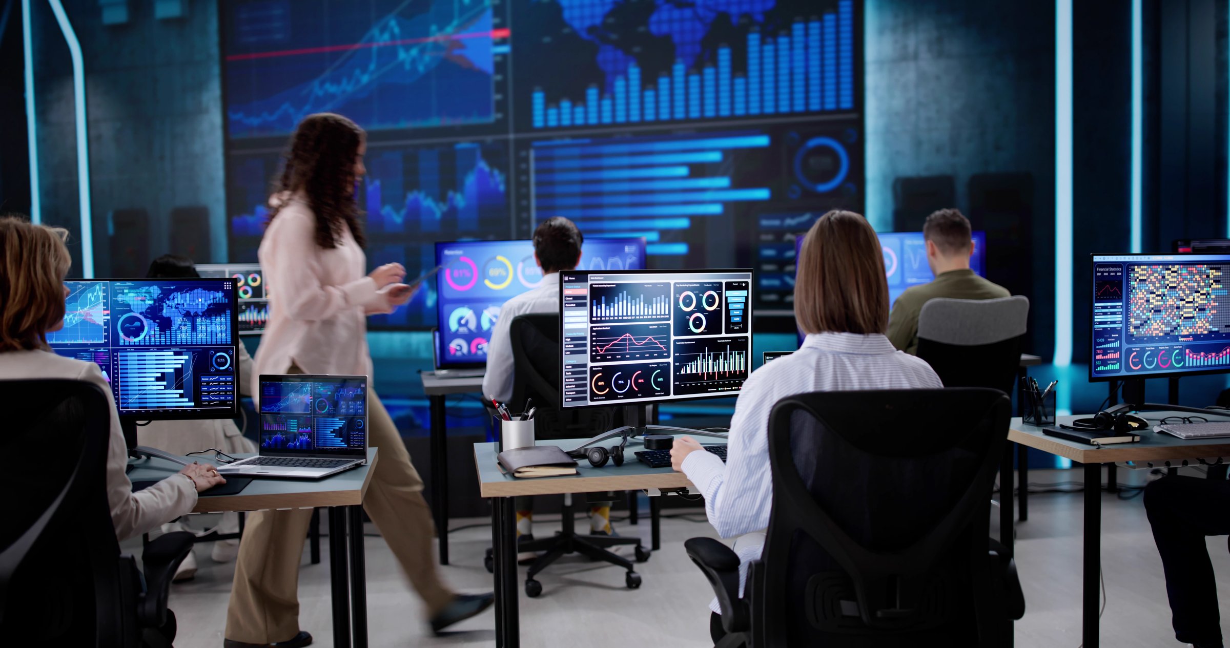 Data center administrator monitors server control on financial KPI dashboard.