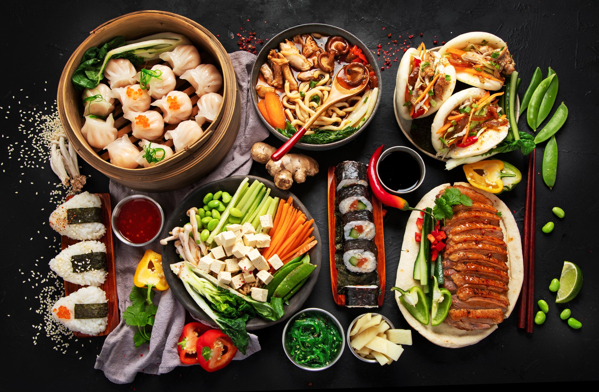 Asian food served on a black background. Asian food concept. Top view.