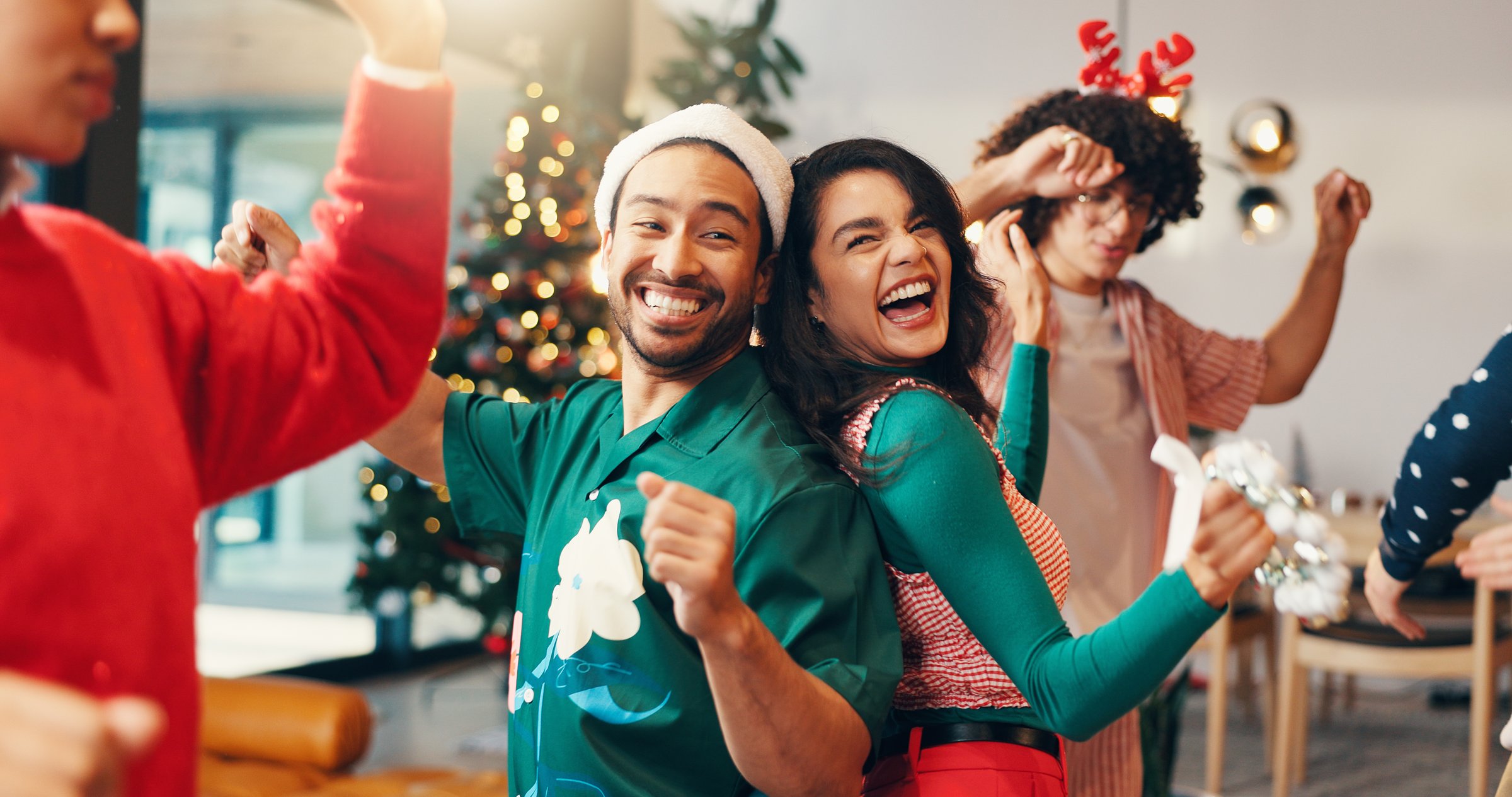 Happy people, christmas and dancing with friends for party or new year celebration at home. Excited, group or energy with smile in joy for december holiday, festive event or fun get together at house