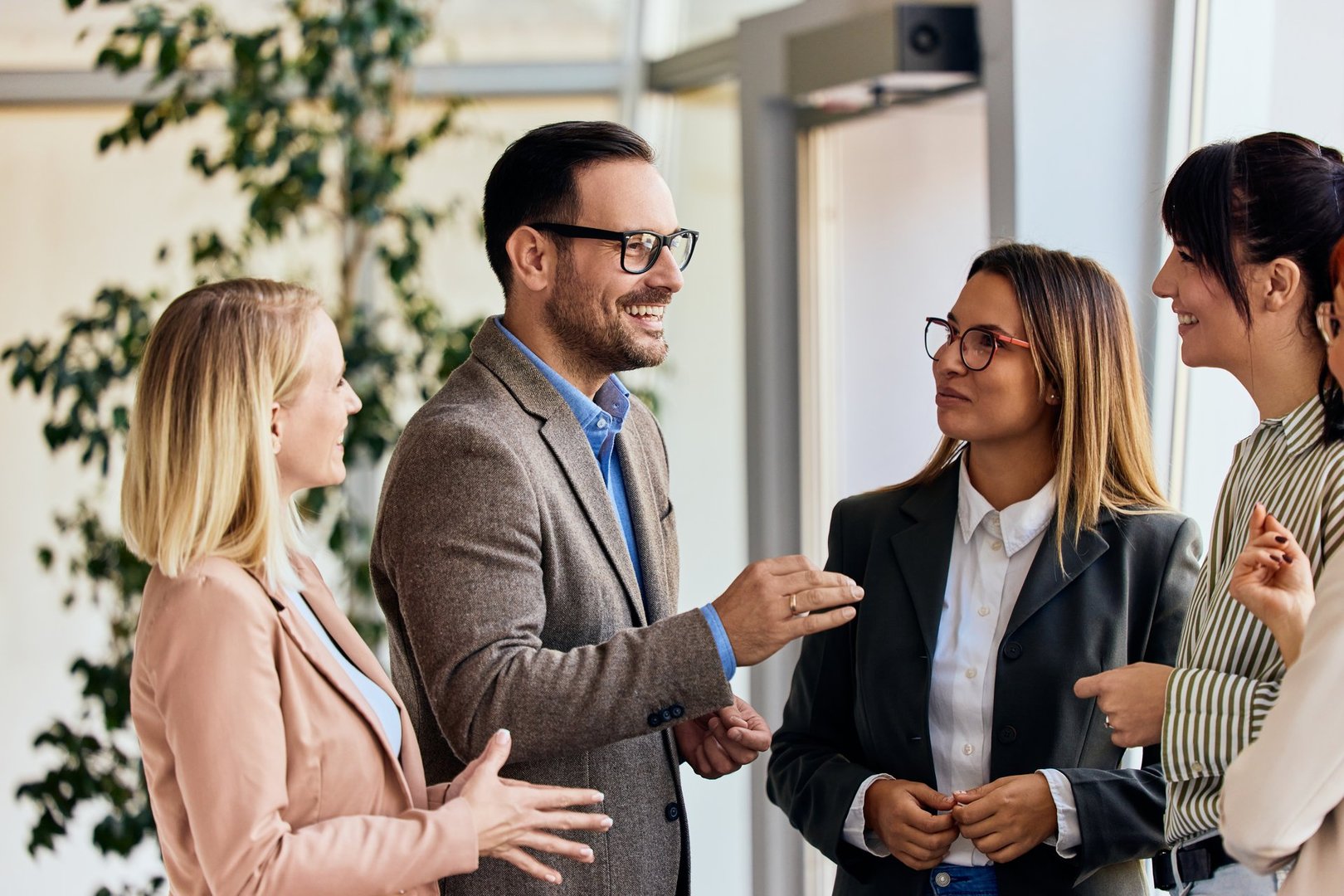 Group of professionals exchanging ideas in a collaborative office environment.