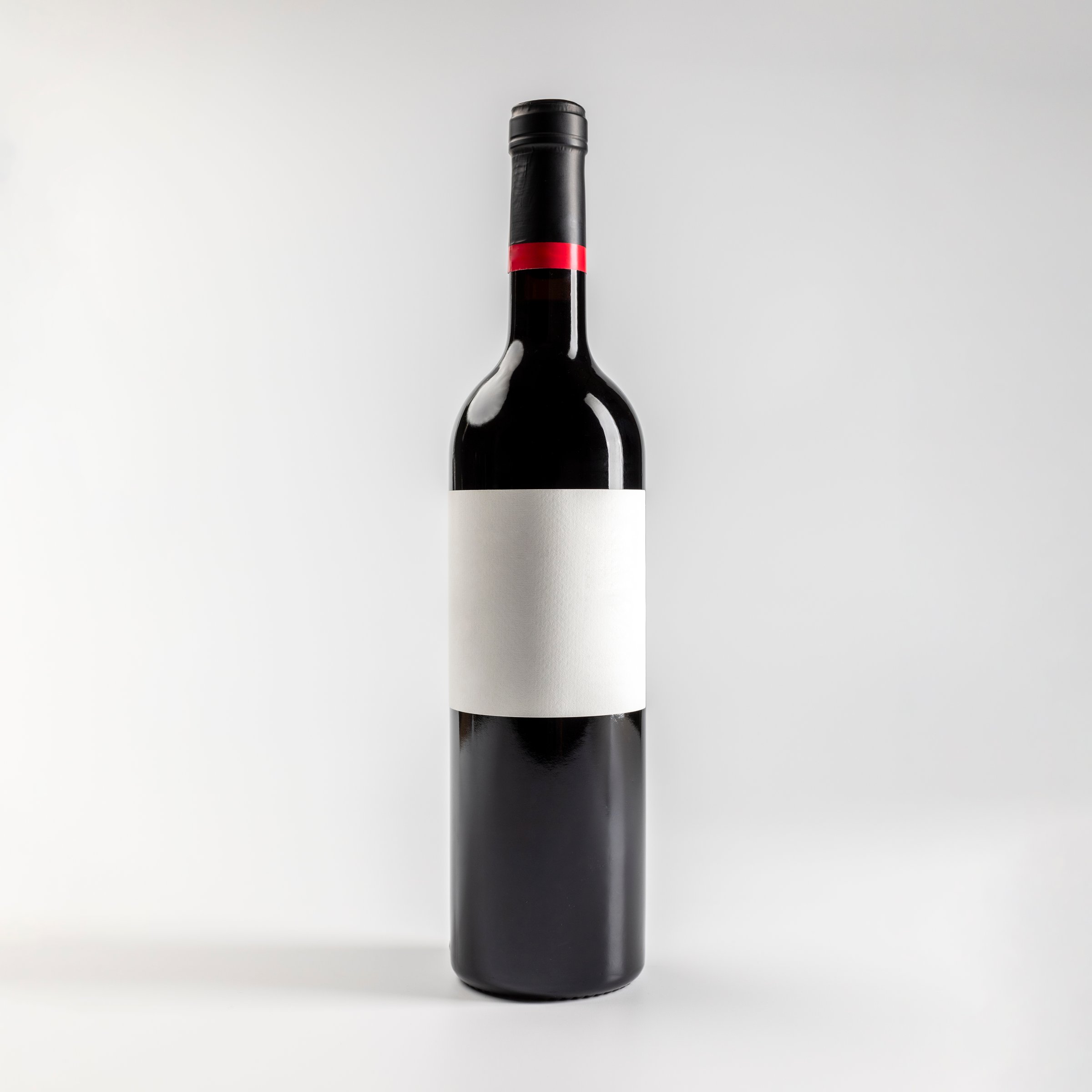 Mockup of bottle of red wine garnacha, on white background with copyspace, 750 ml, real photo