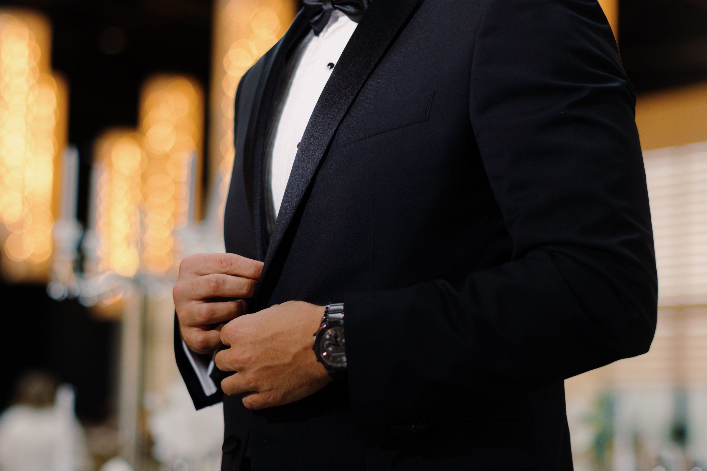 A man in a black tuxedo, showcasing elegance and style at a formal event