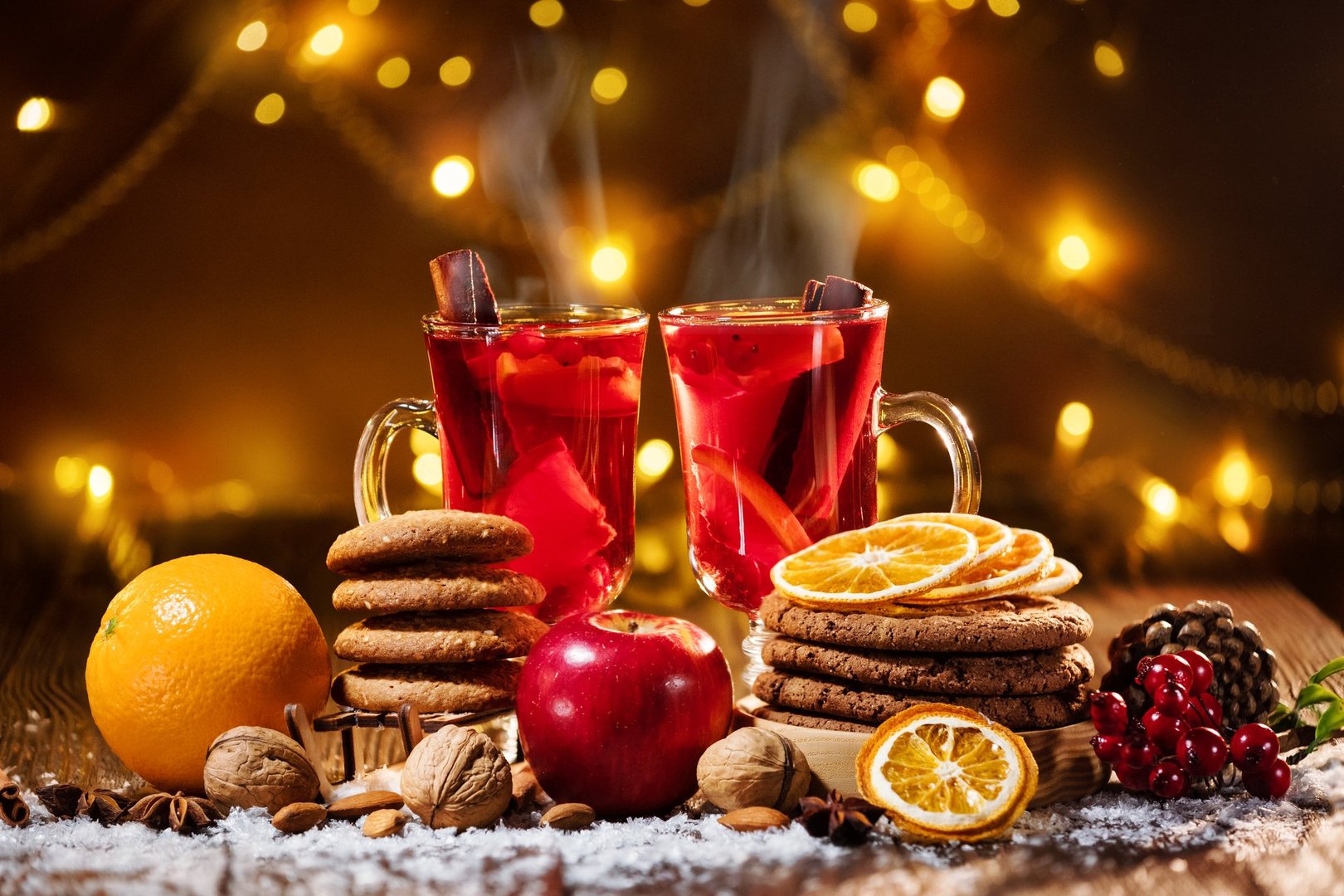 Close-up of traditional Christmas mulled wine with spices and cookies at Christmas market and fun fair