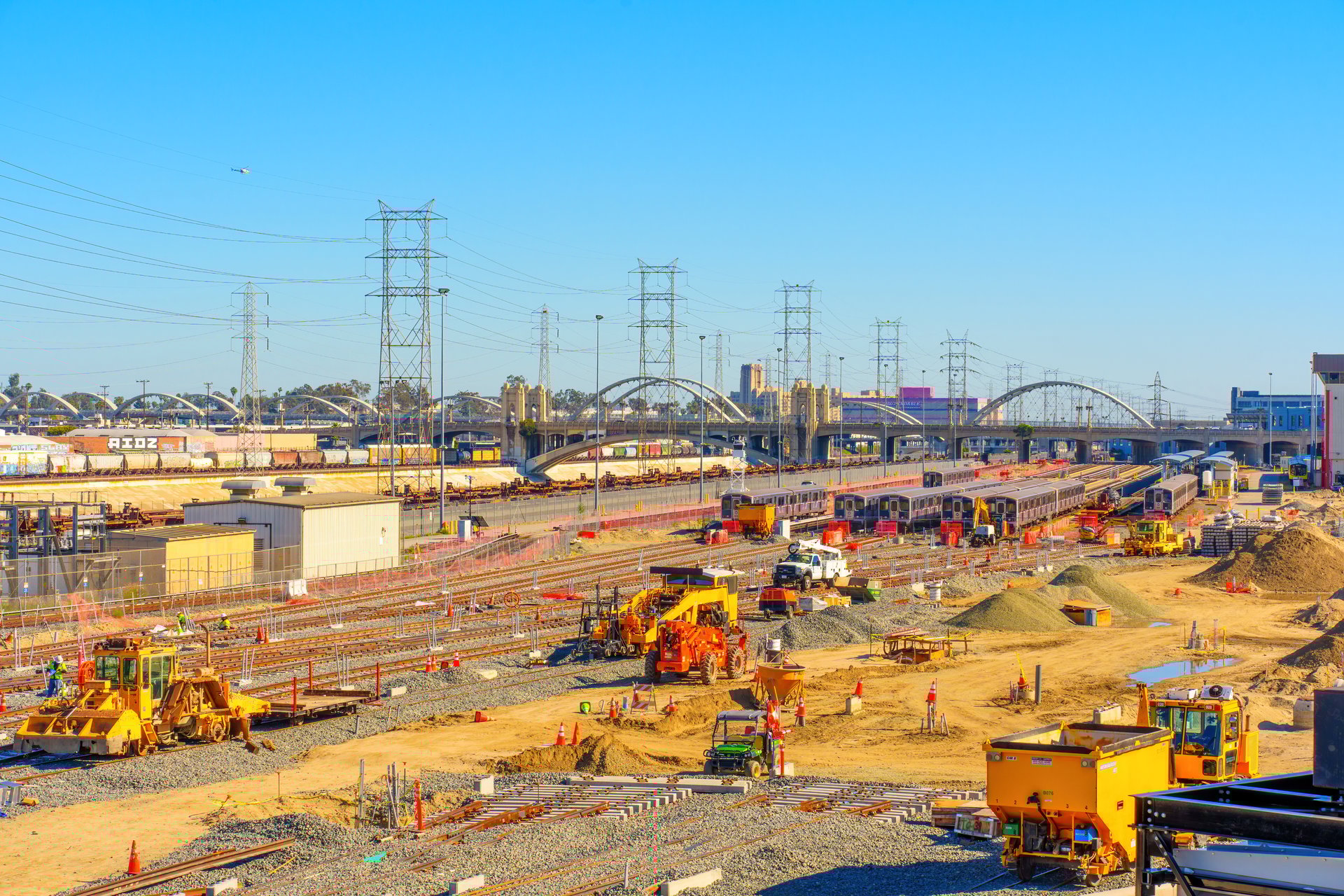 Los Angeles, California - April 4, 2024: Overview of construction site near the 6th Street Bridge featuring rail lines, heavy machinery, and ongoing urban development.