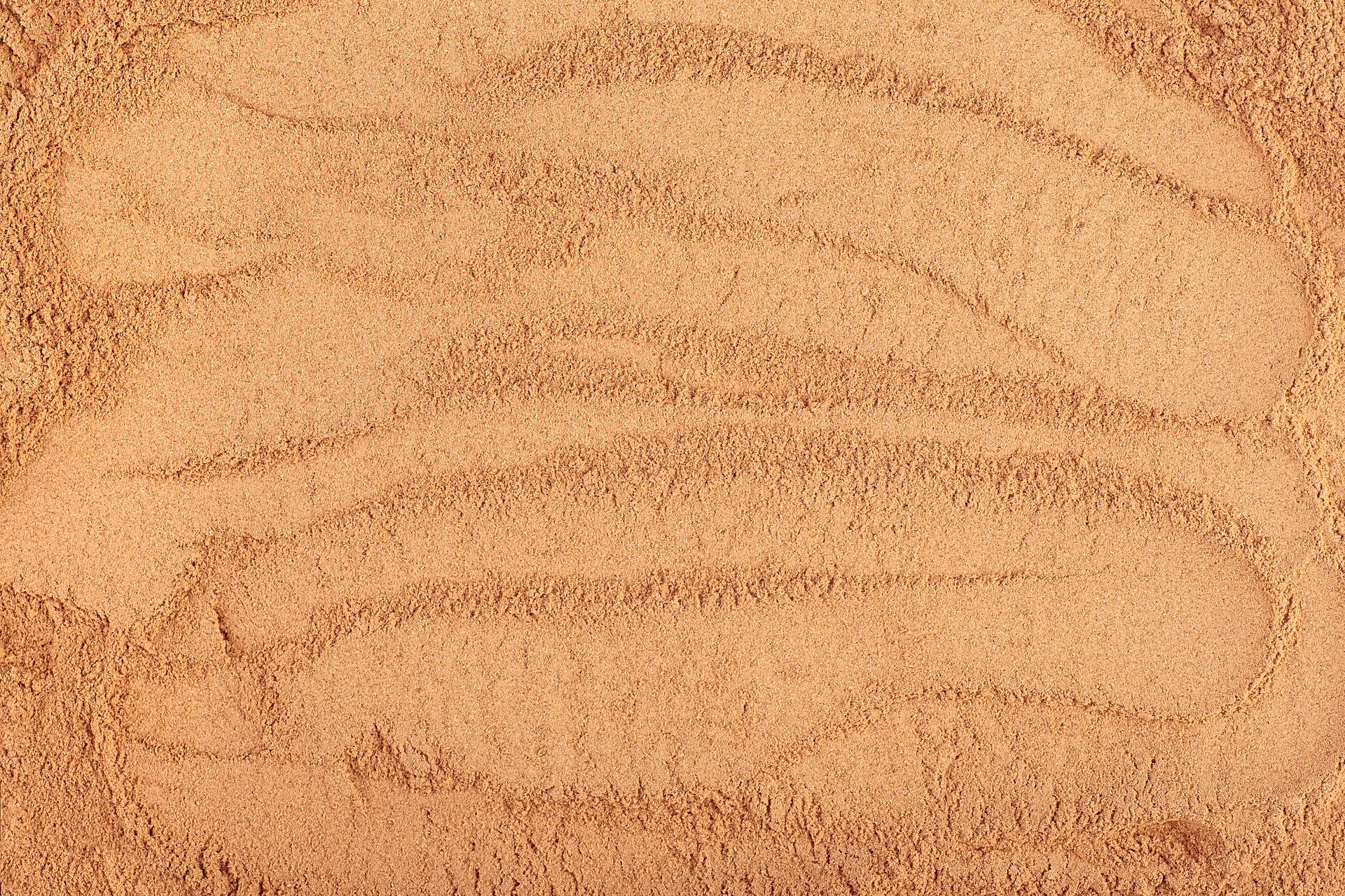 Incense - chandan or sandalwood powder pile as background, top view.