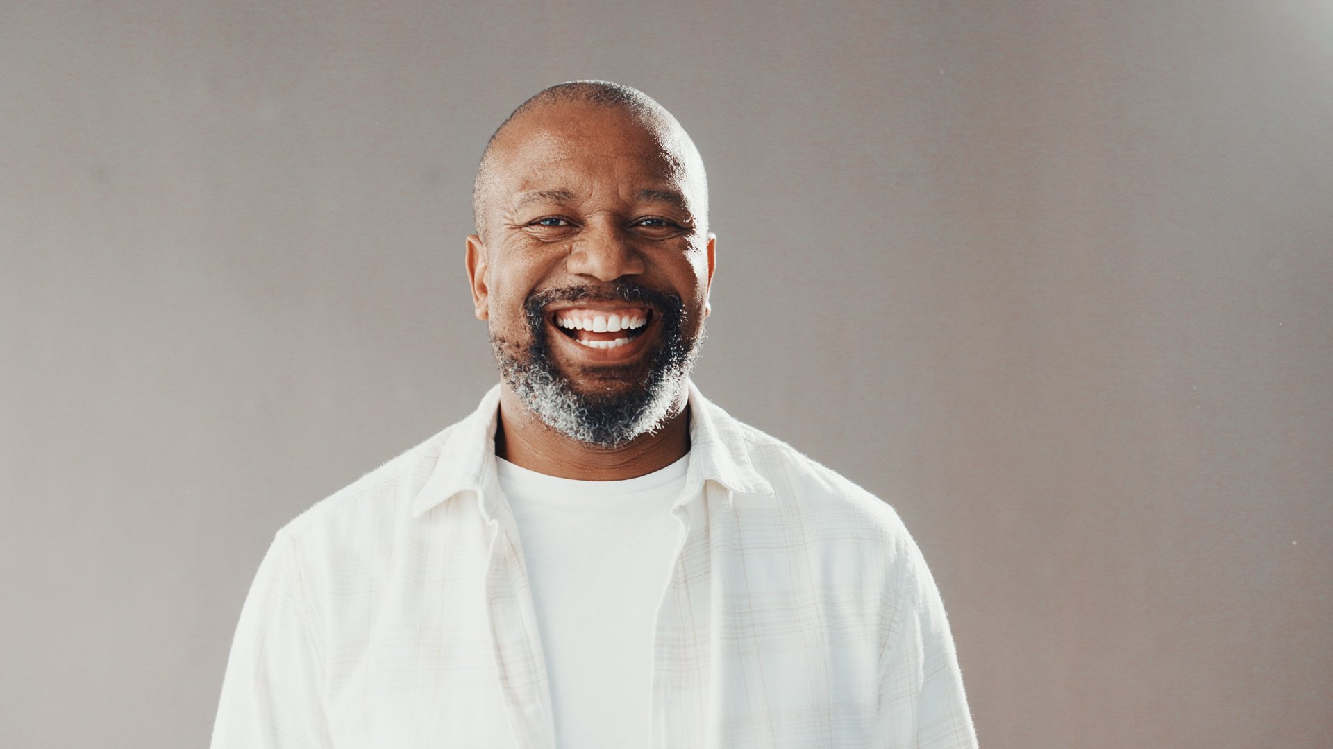 Happy, professional and portrait of black man in studio with confidence for career development. Smile, male person and mature African financial advisor with pride for job by gray background.