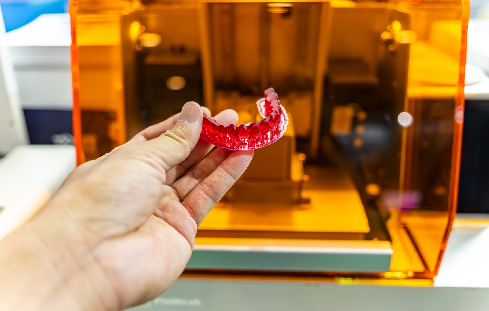 Dental technician modeling frame for implant production from a 3d printer at the laboratory