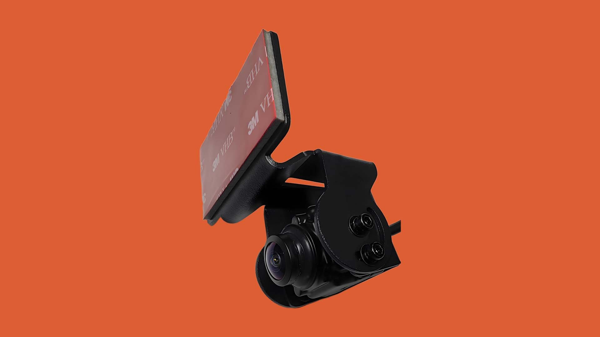 A black security camera with a branded red mounting pad against an orange background.