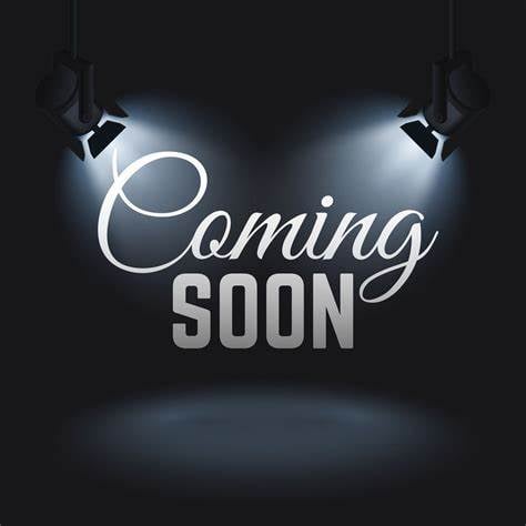 "Coming Soon" text illuminated by spotlights on a dark background, creating a dramatic announcement effect.