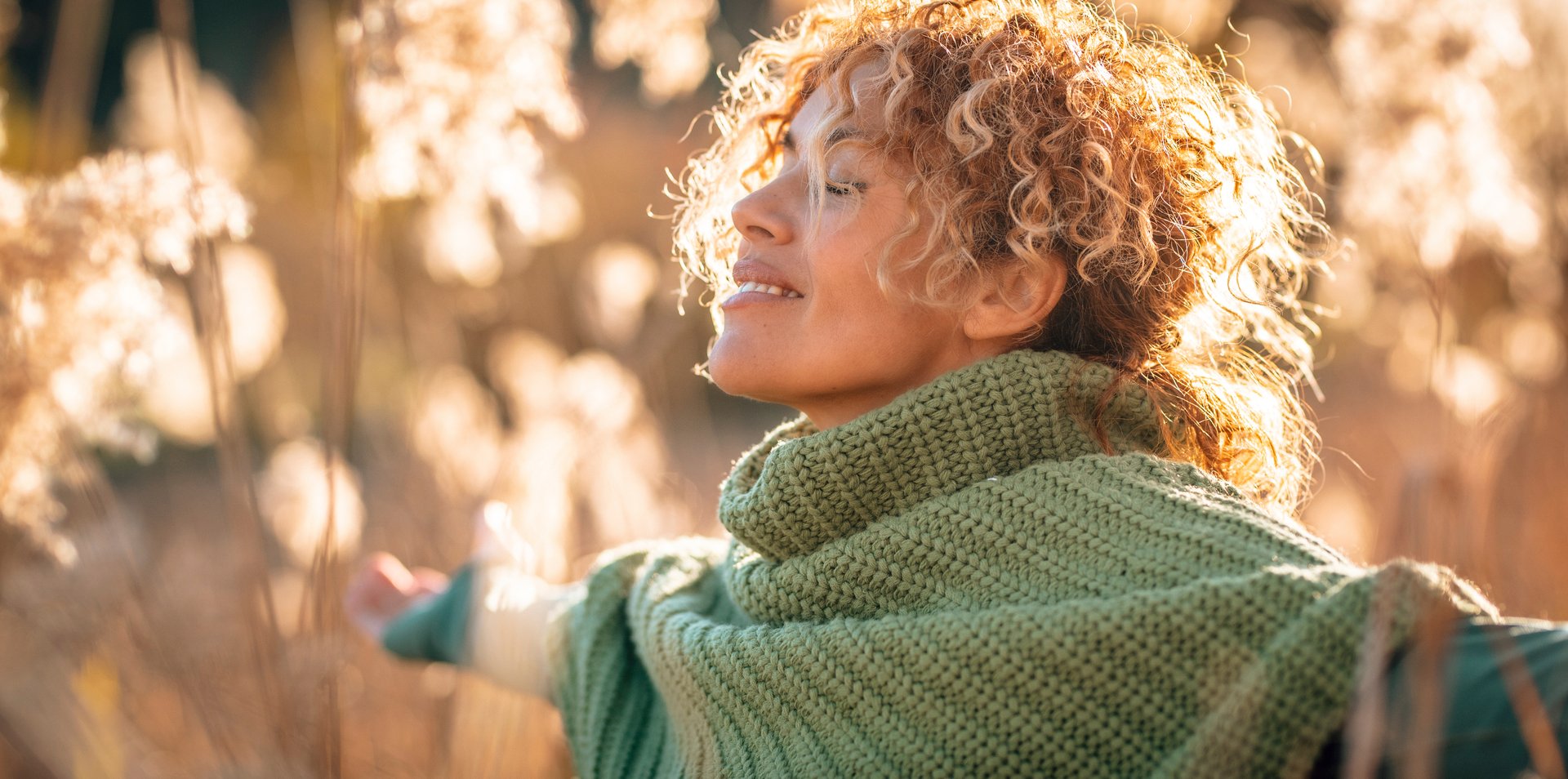 One beauty woman with happy and idyllic expression on face opening arm and enjoying sunset light in the field in scenic outdoor leisure activity. People loving life and healthy lifestyle concept. Life
