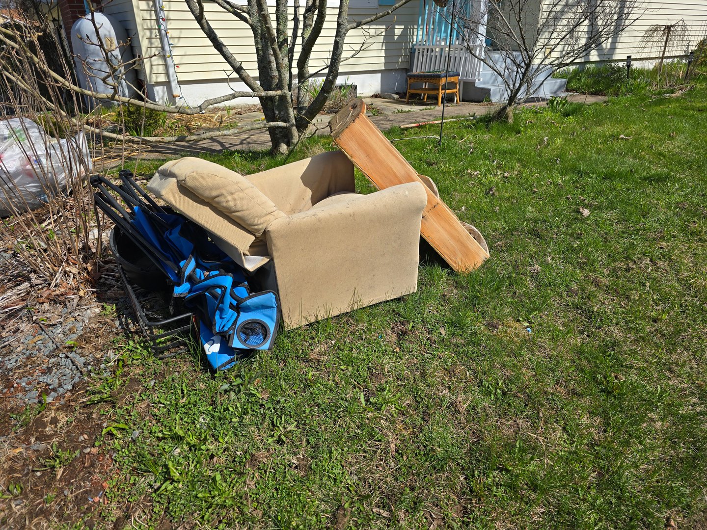 A smakll pile of trash on a lawn for cleanup.