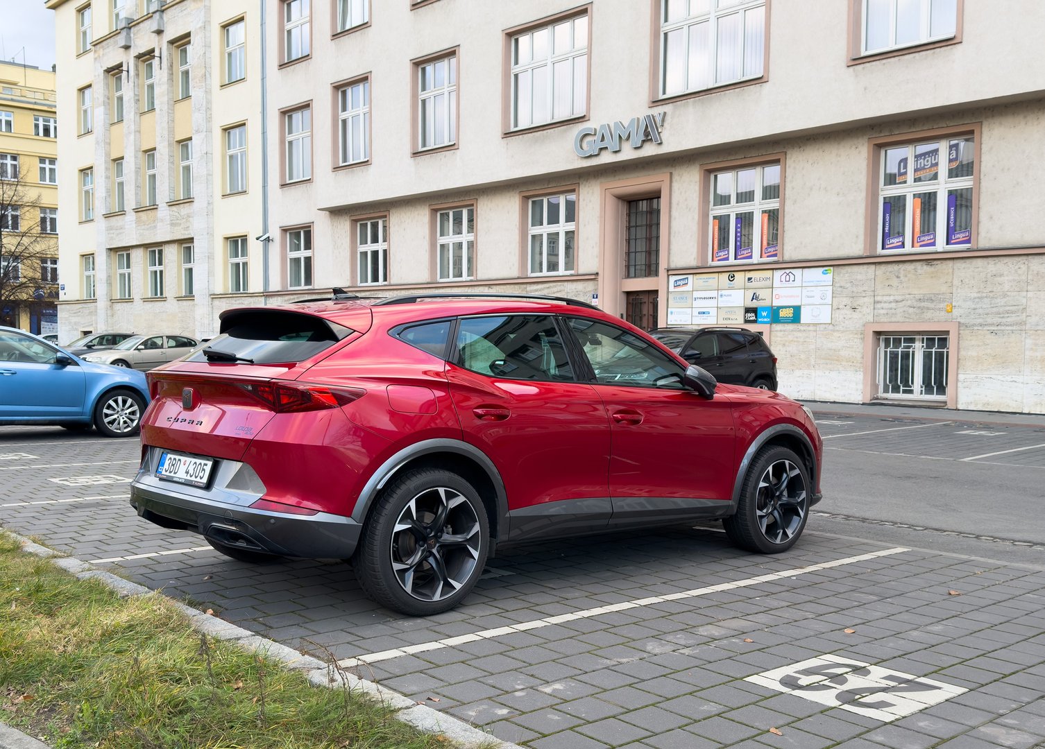 Ostrava, Czechia - January 31, 2025: Red Cupra Formentor crossover car parked on street, rear side view