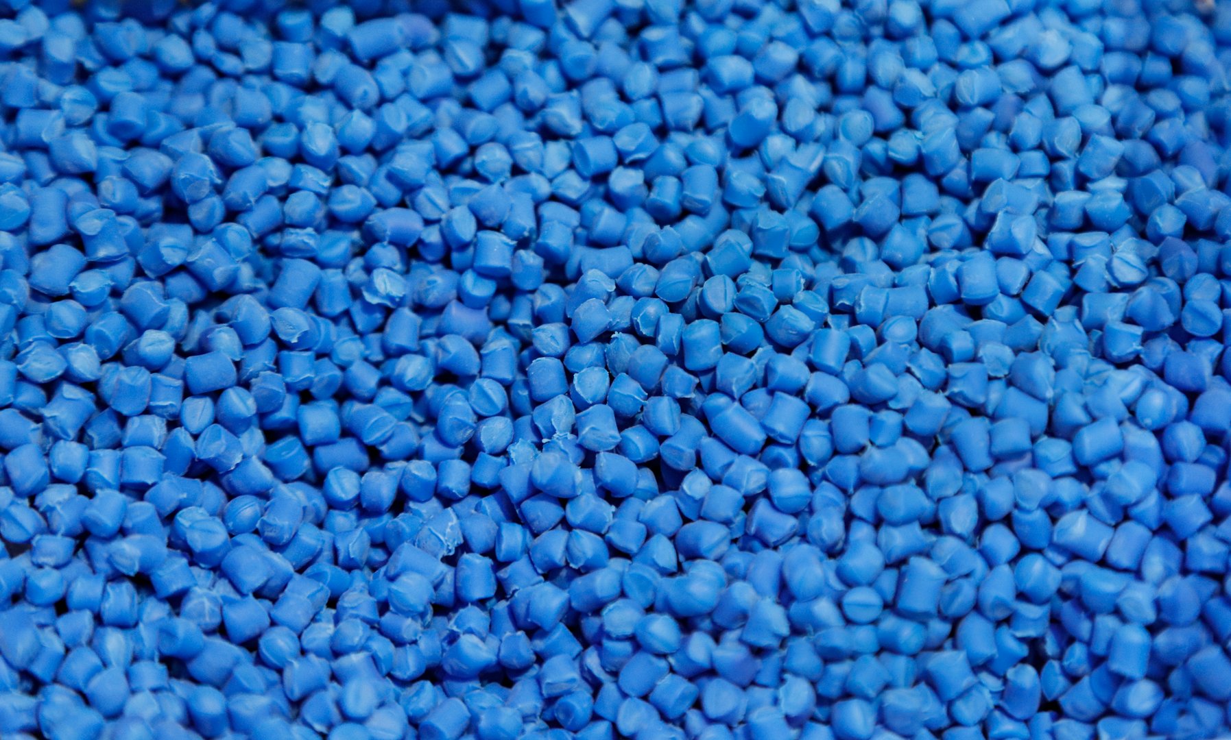 The pile of blue pellets materials for plastic injection process. The raw material from petrochemical products.