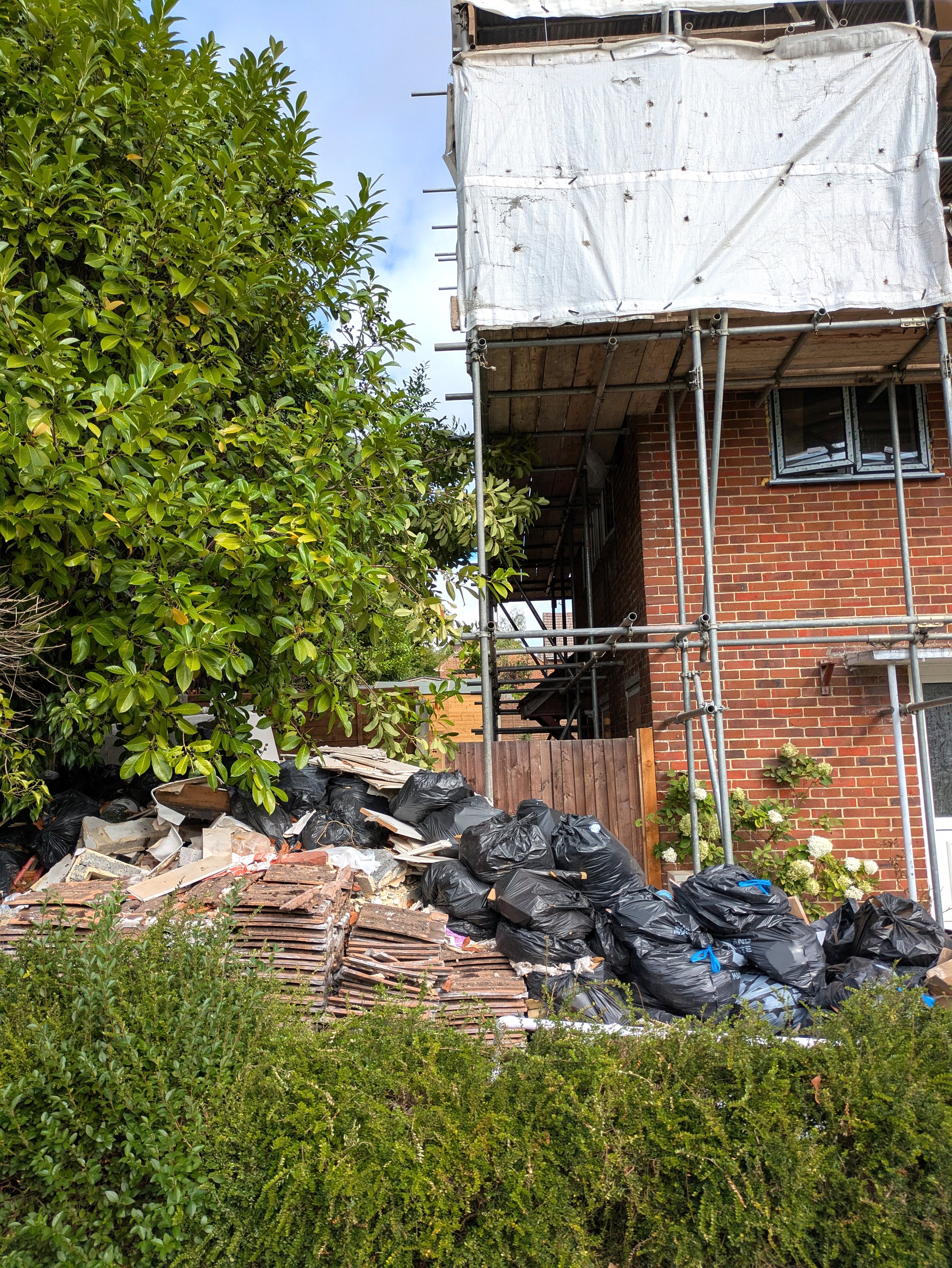 DIY project dumped rubbish and roof tiles project gone wrong in garden