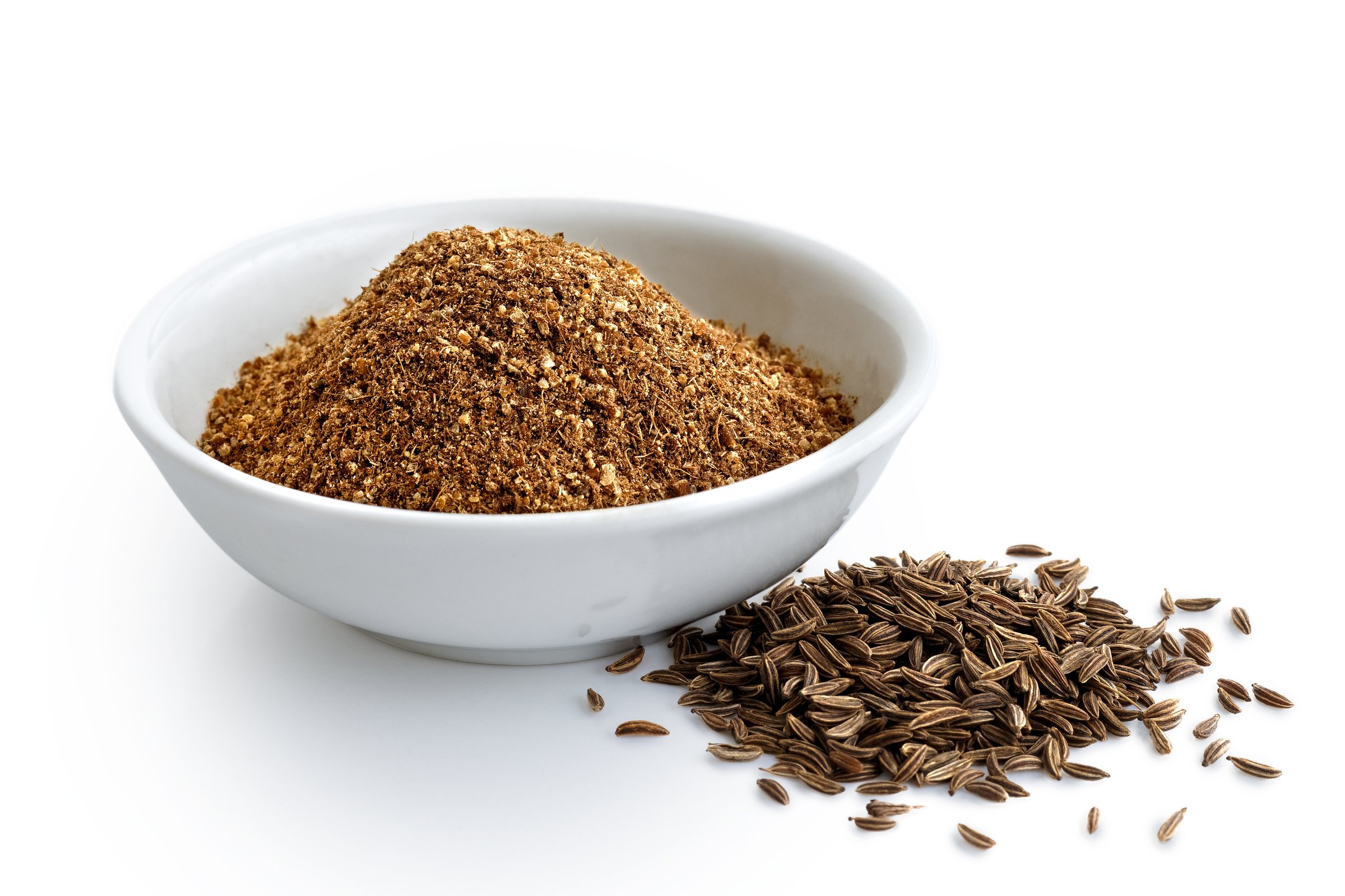 Ground cumin in white ceramic bowl