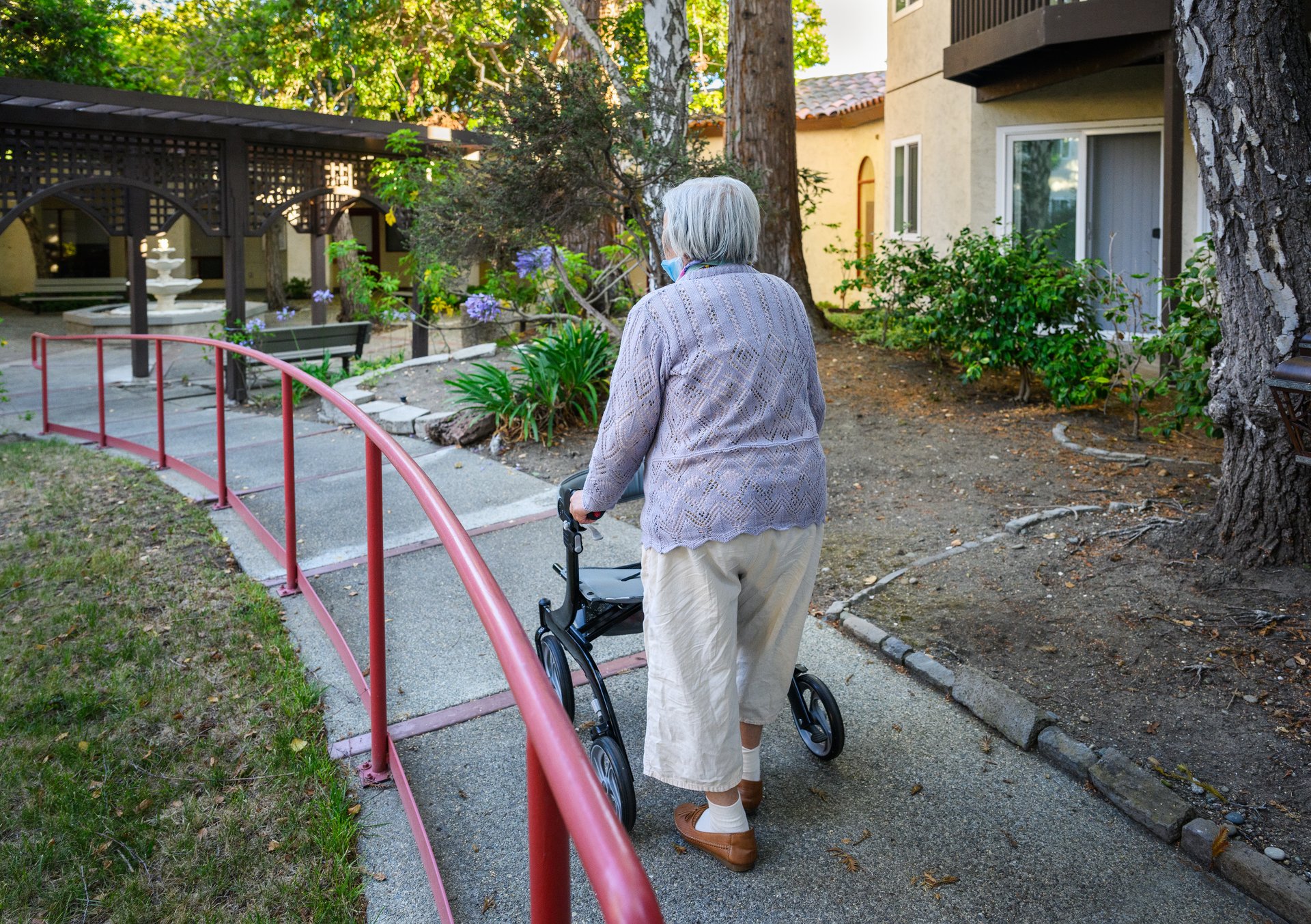 Elderly woman using mobility walker outdoors