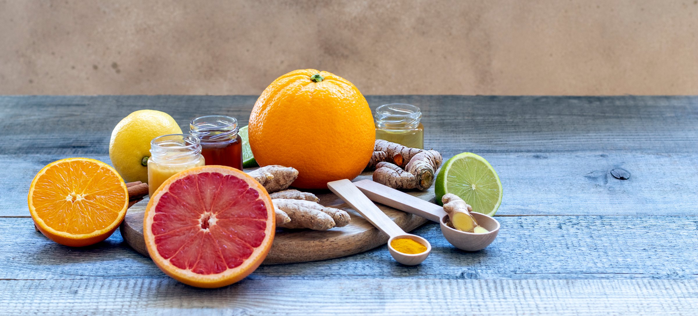 Composition with honey and oranges as natural cold remedies on the old wooden background
