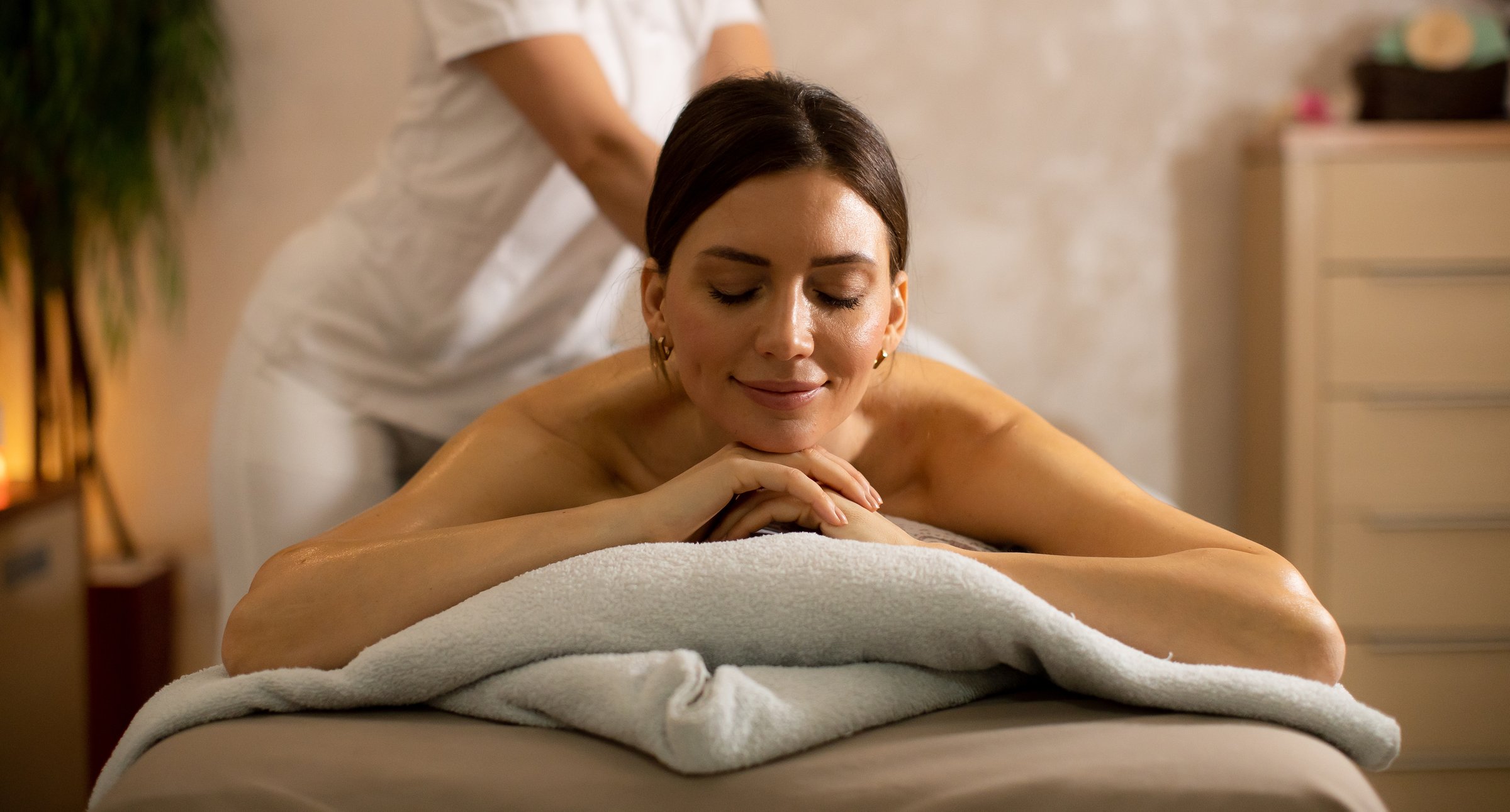 Thai massage therapist providing treatment in wellness center