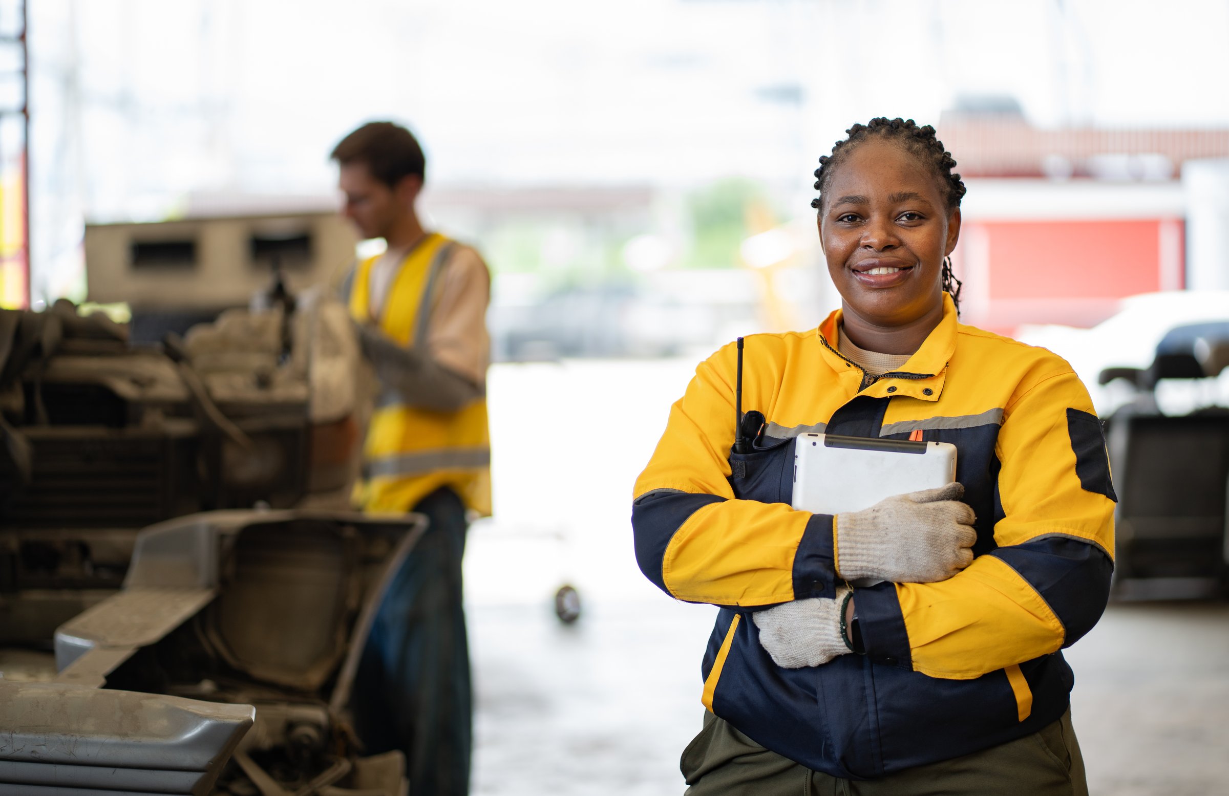 Portrait African American technician or engineer with Caucasian technician and auto part background