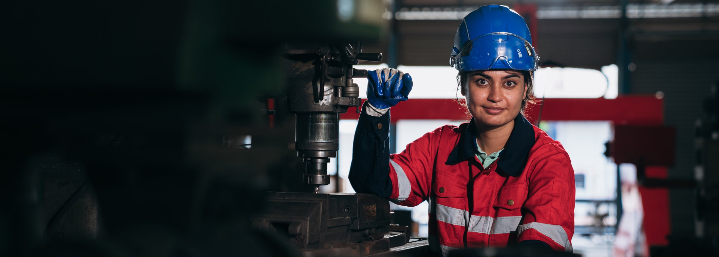 Portrait of Industrial worker inspecting and check up machine at factory machines. Technician working and checking Material or Machine at industry manufactory.