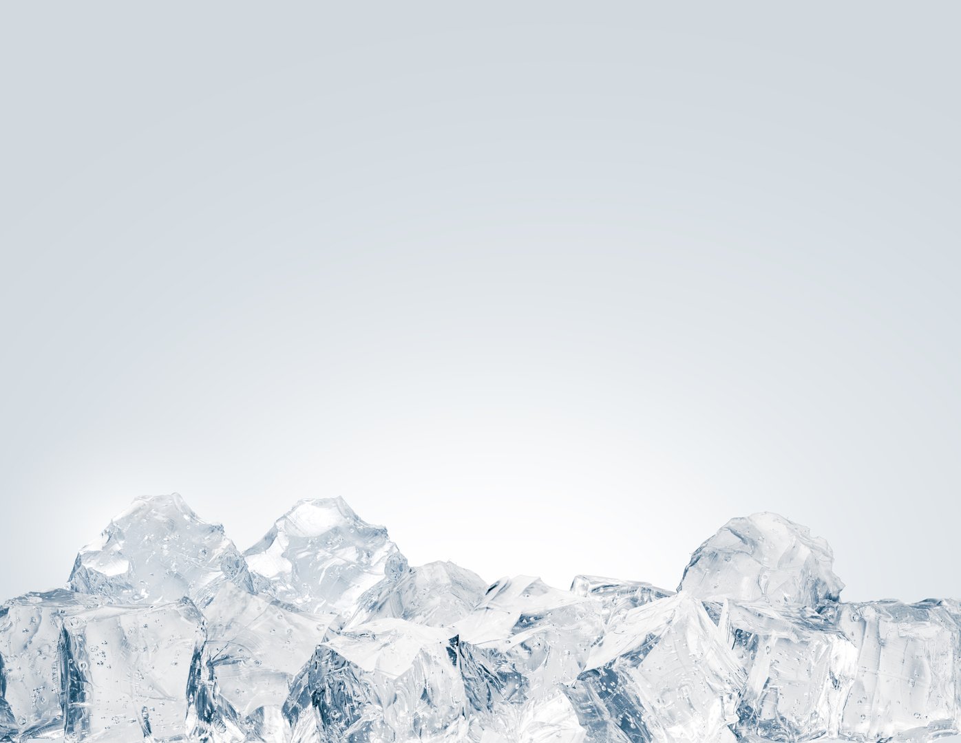 A heap of crystal clear ice cubes on a white background.