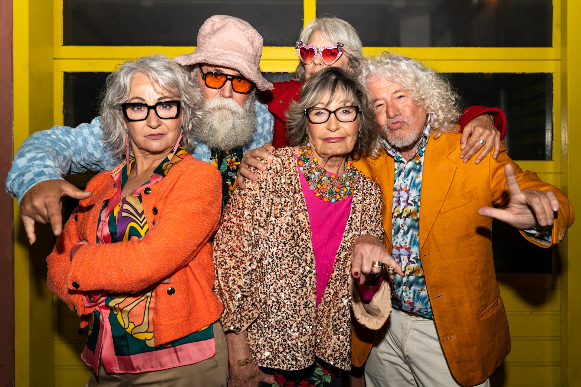 Group of happy senior friends with fancy clothing having party in the night on city streets - Cheerful elderly people wearing fashionable clothes celebrating and having fun outdoors