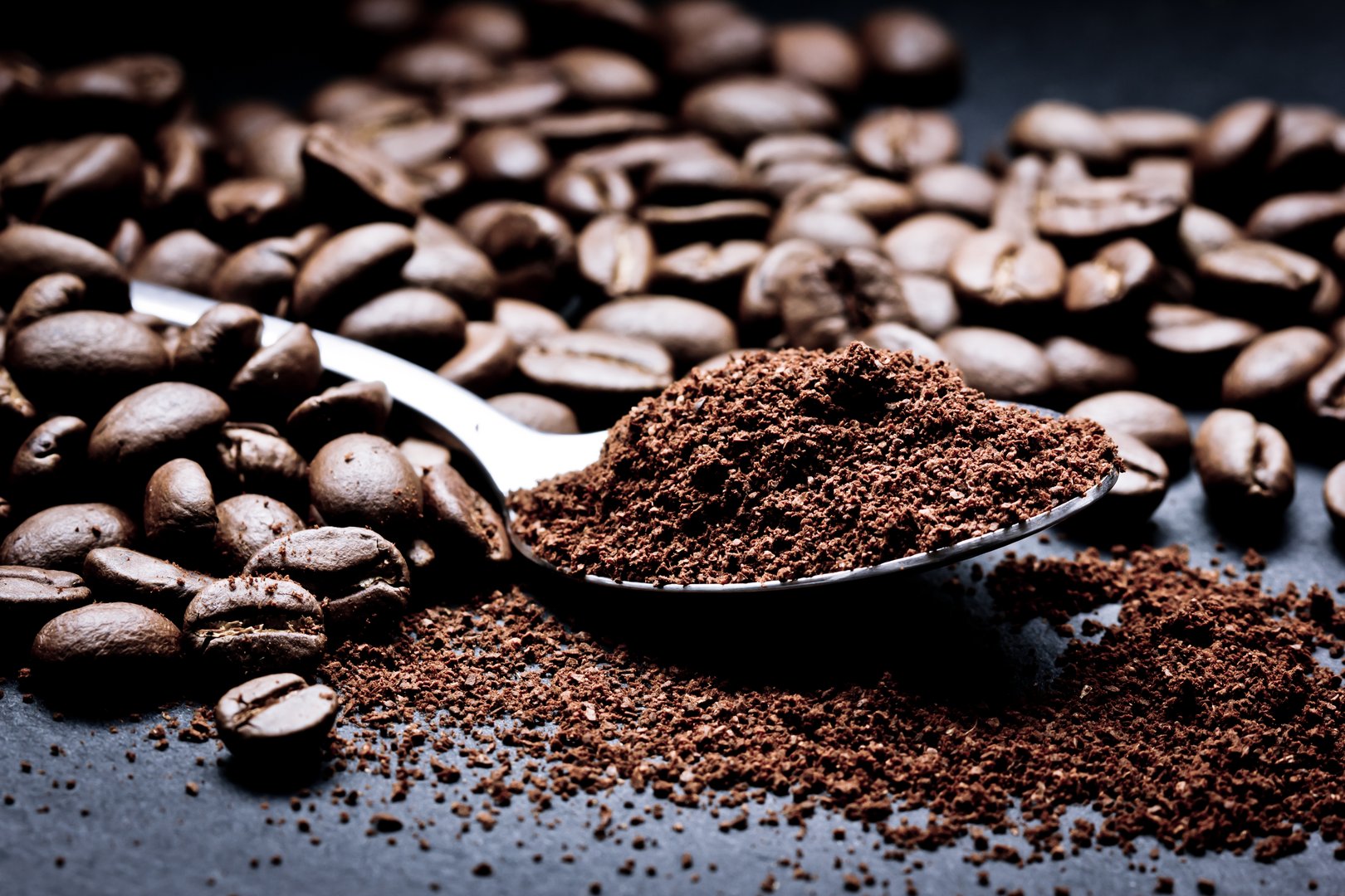 Black artistic coffee seeds. Coffee beans texture.