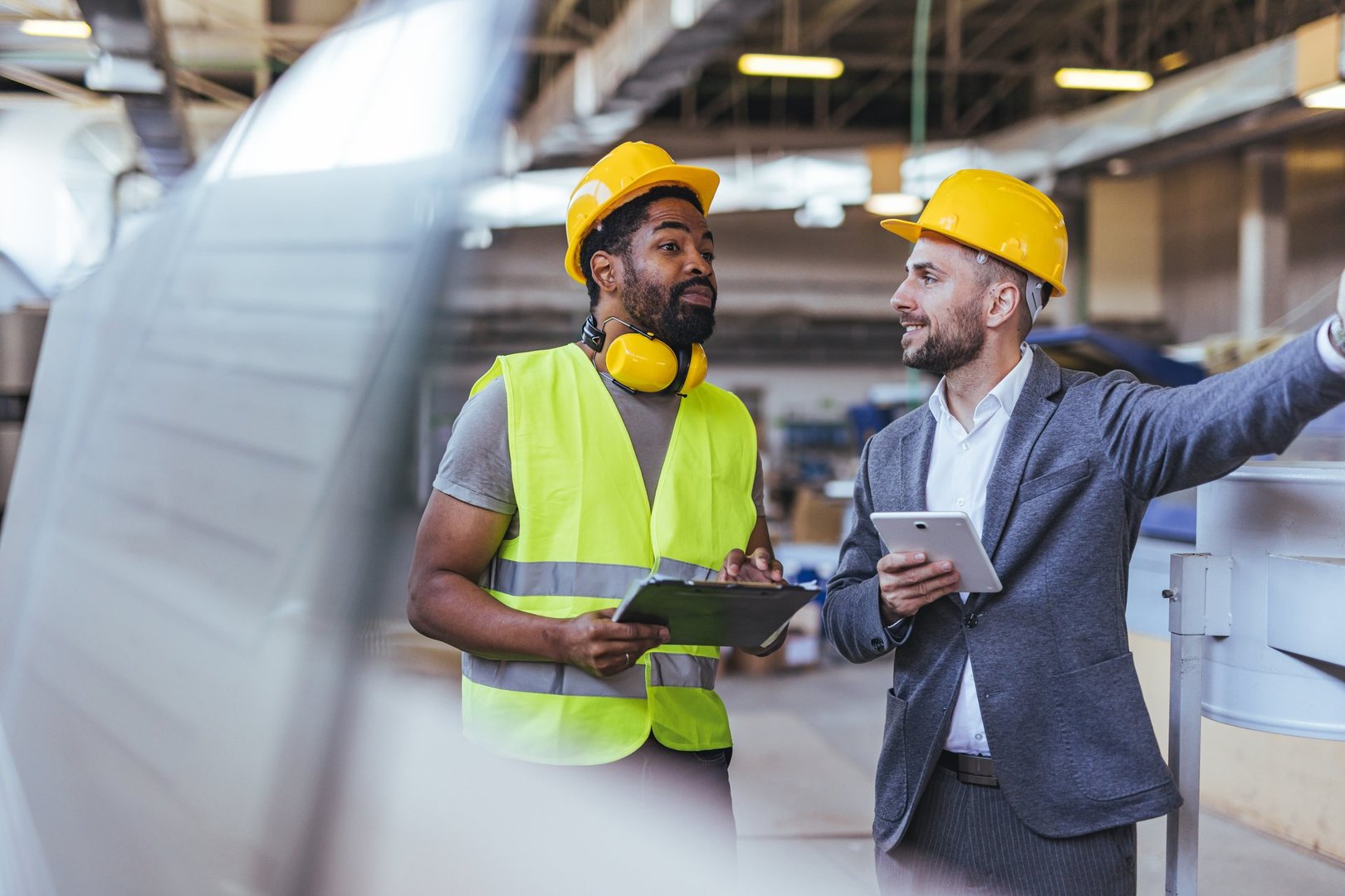 Industrial workers discussing in factory