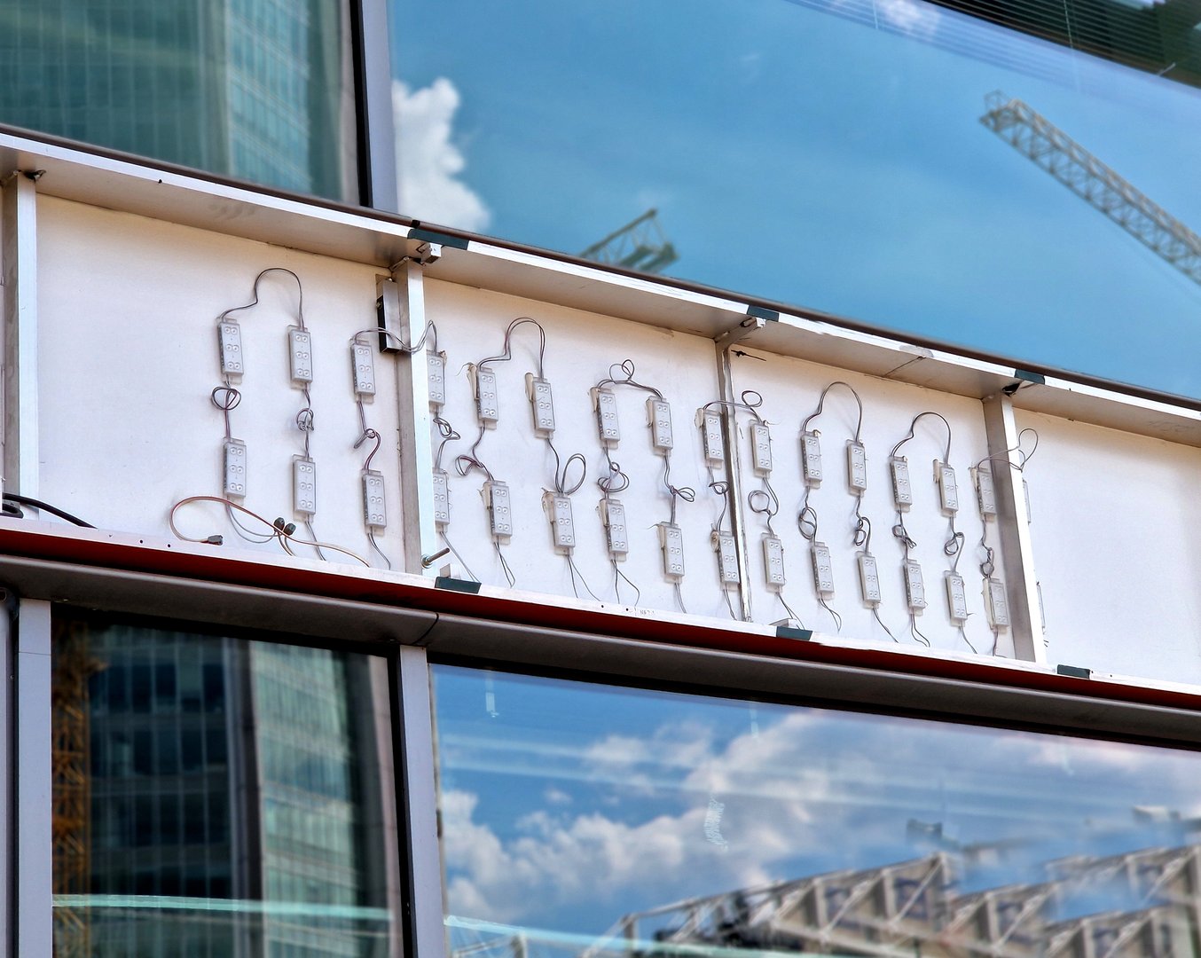 Professional sign installation team working on channel letters on a building exterior