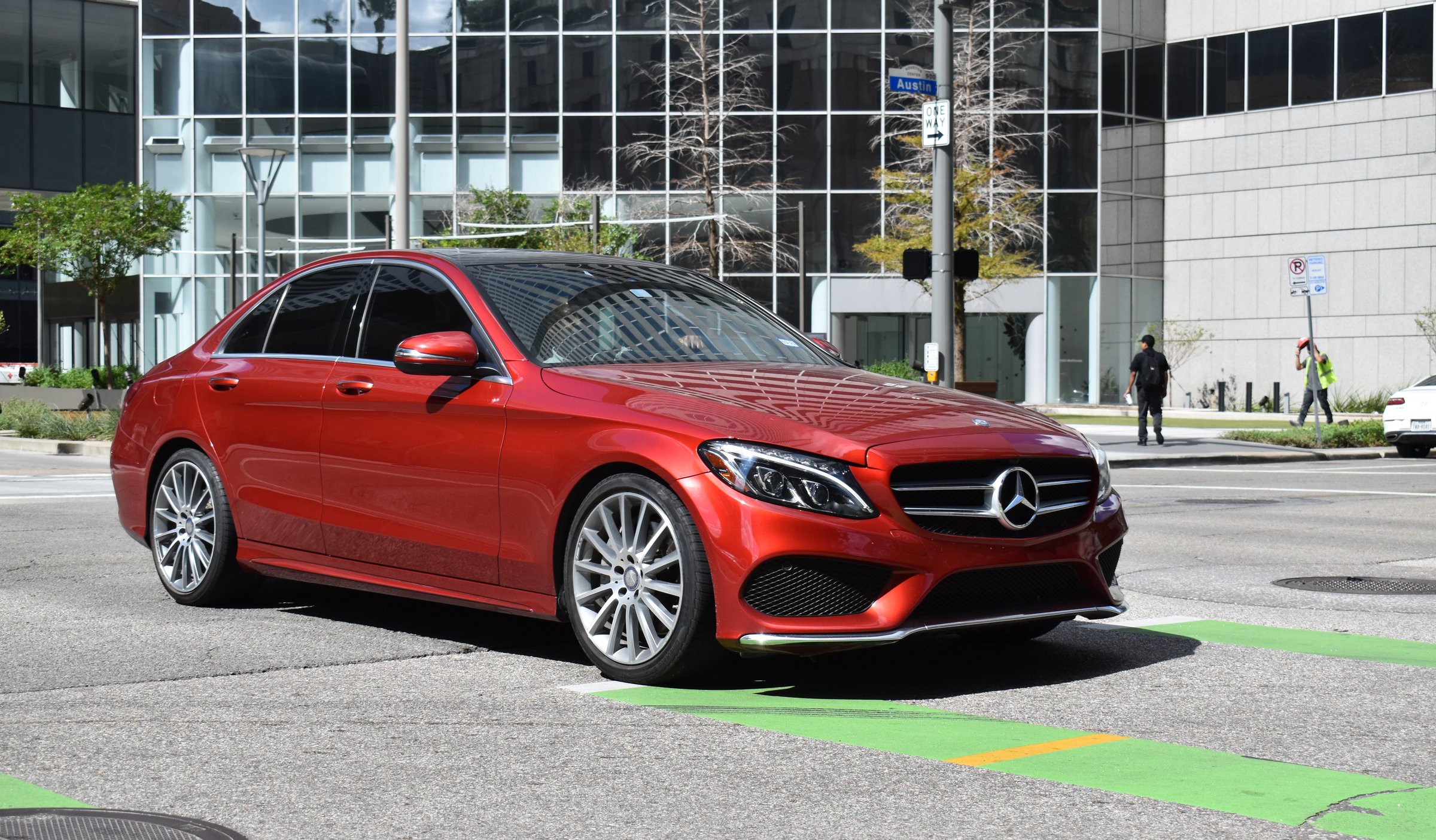 Houston, TX USA 10-4-2024 - A red Mercedes-Benz C350 4matic AMG luxury sedan, cruising in the downtown financial district of the city.