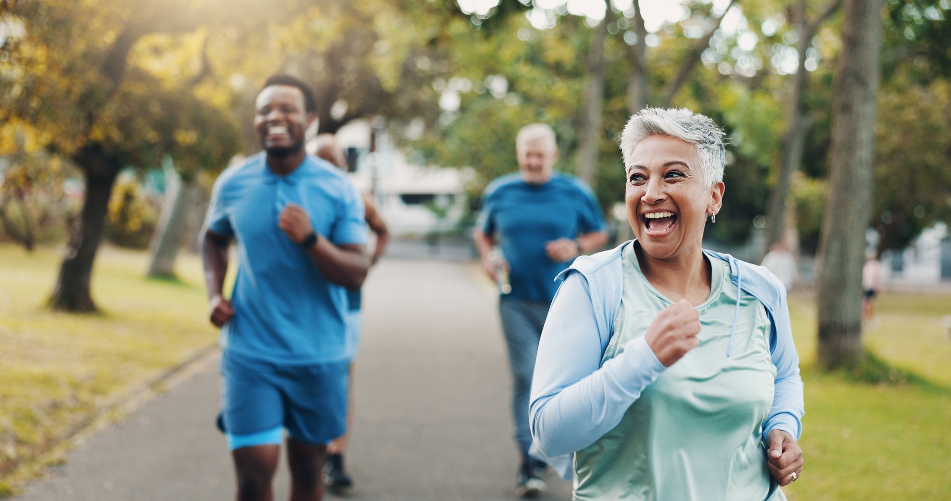 Senior, woman and running for fitness outdoor of mobility training, exercise and morning routine. Elderly, people and coach with challenge, workout support and cardio performance for wellness at park
