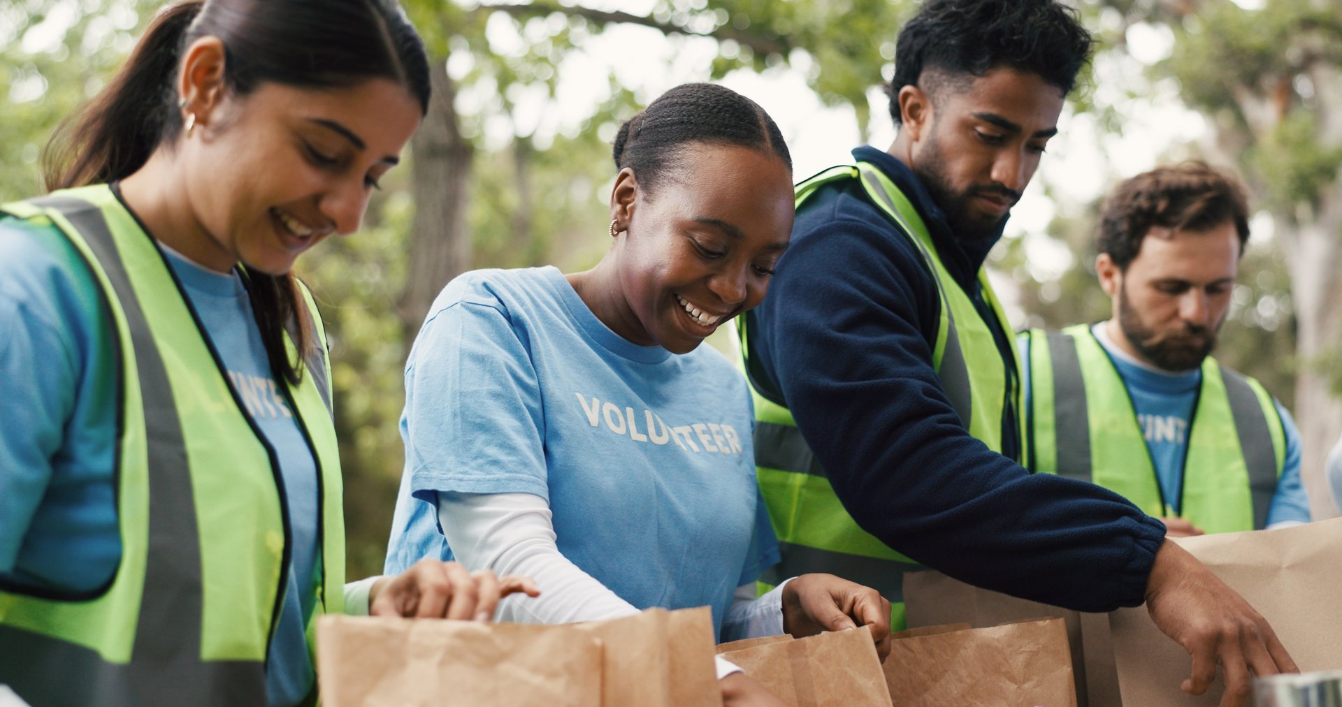 African American volunteers with donations and food boxes doing community service