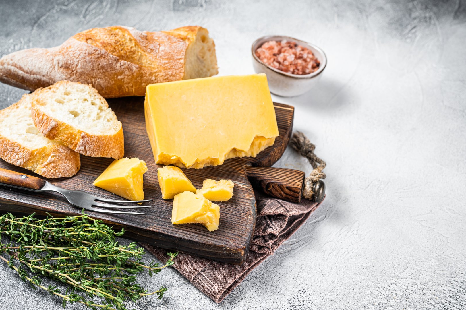 Gouda cheese with bread ready for cooking sandwich. White background. Top view. Copy space.