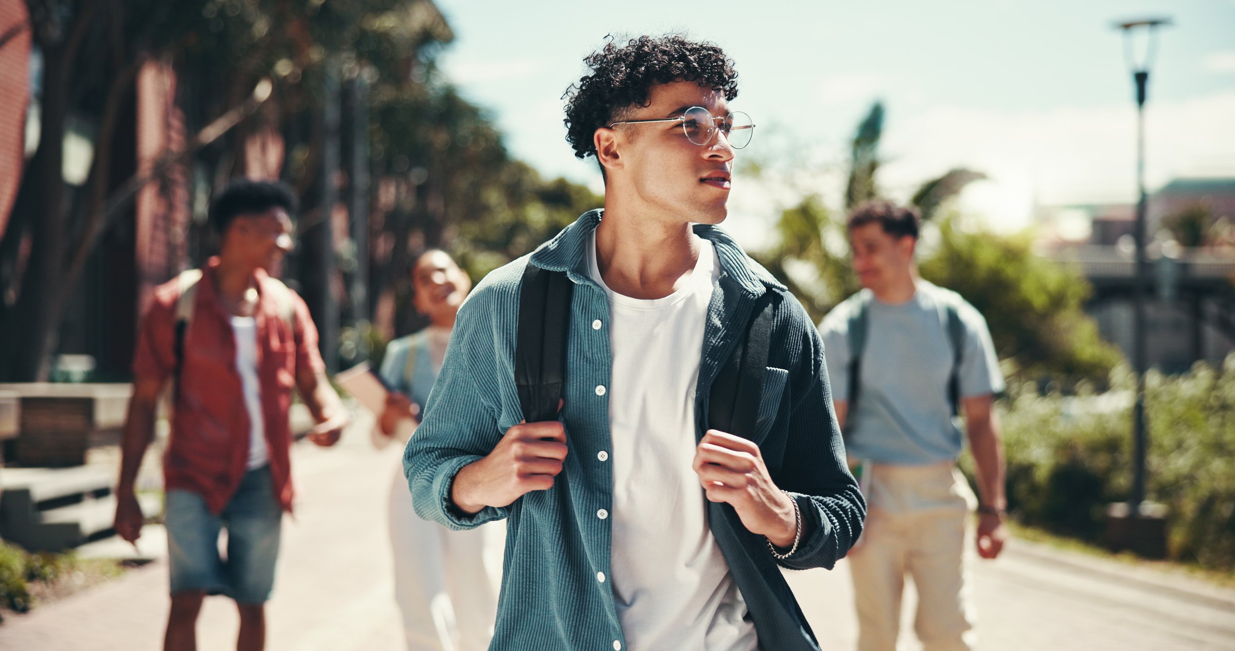 Education, campus and walking with student friends outdoor together for learning or study at university. College, future and thinking with learner group at school for knowledge or scholarship