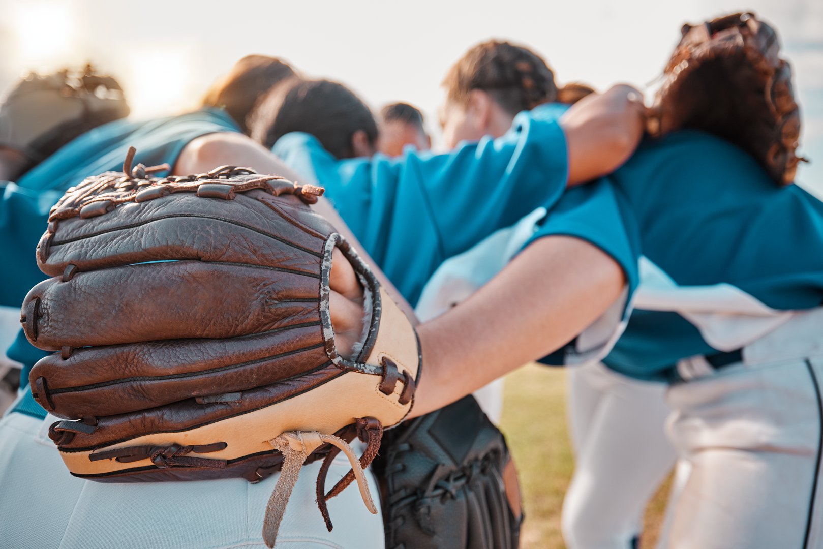 Baseball people and sport team together for huddle at match game on field for motivational support. Professional girl athlete softball group prepare to play outdoor tournament with strategy talk.