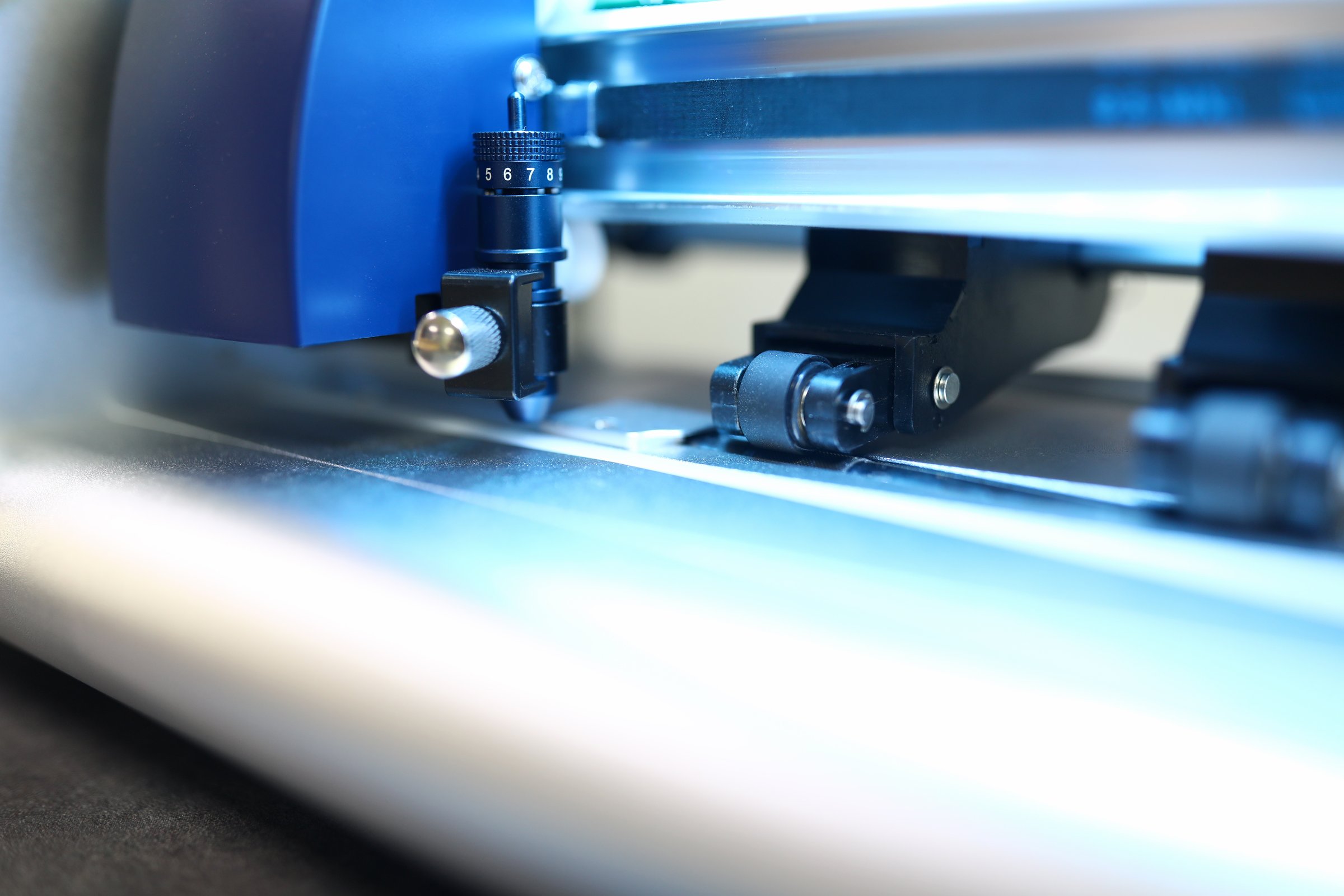 Close-up of electronical modern printer in action. Detailed picture of machine working in process. Metal details. Technology and typography agency concept