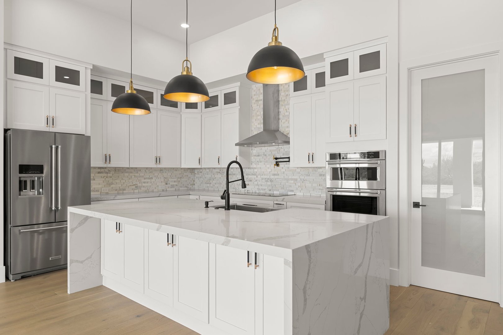 Modern kitchen renovation with custom cabinets, quartz countertops and premium fixtures