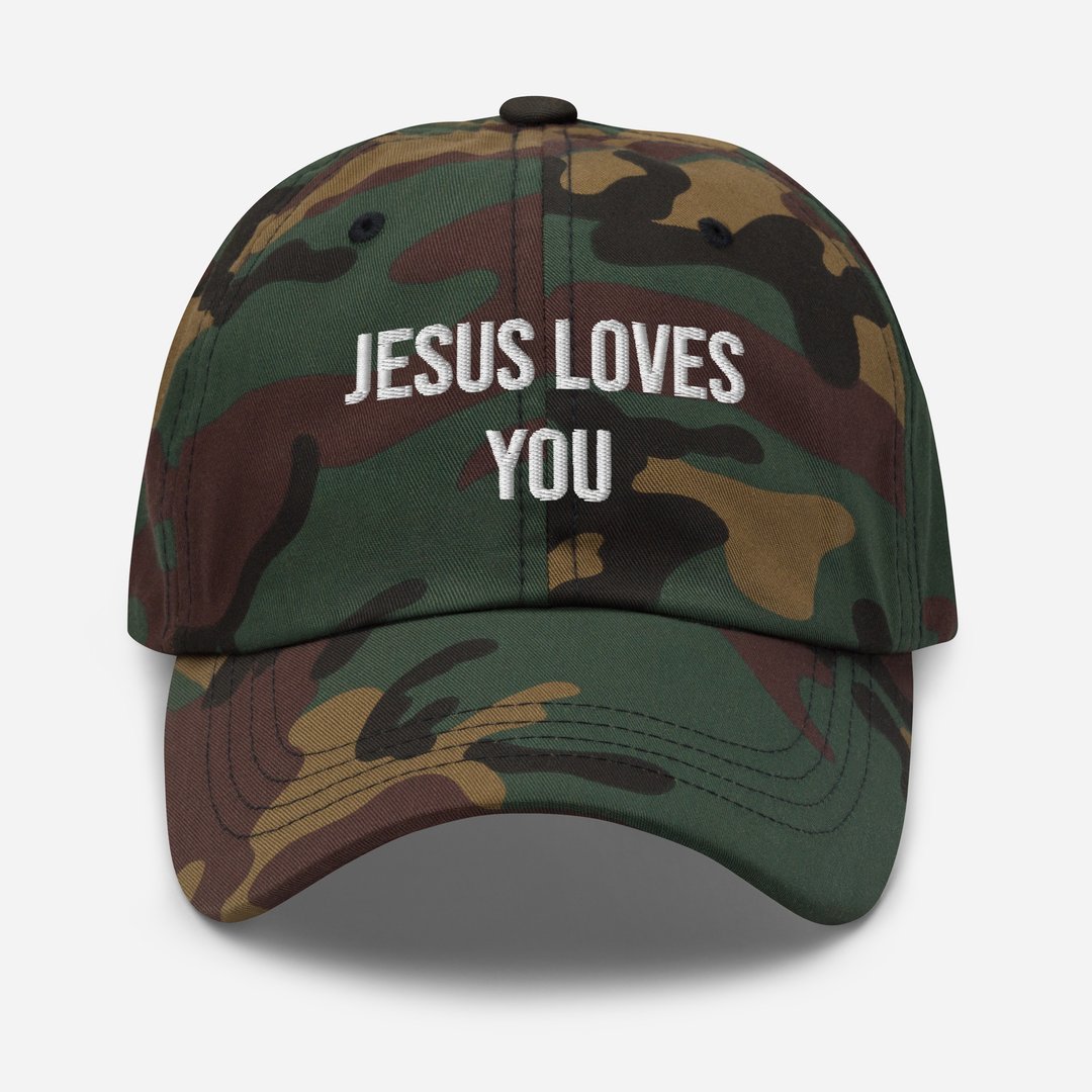 Camouflage baseball cap with "JESUS LOVES YOU" embroidered in white on the front.