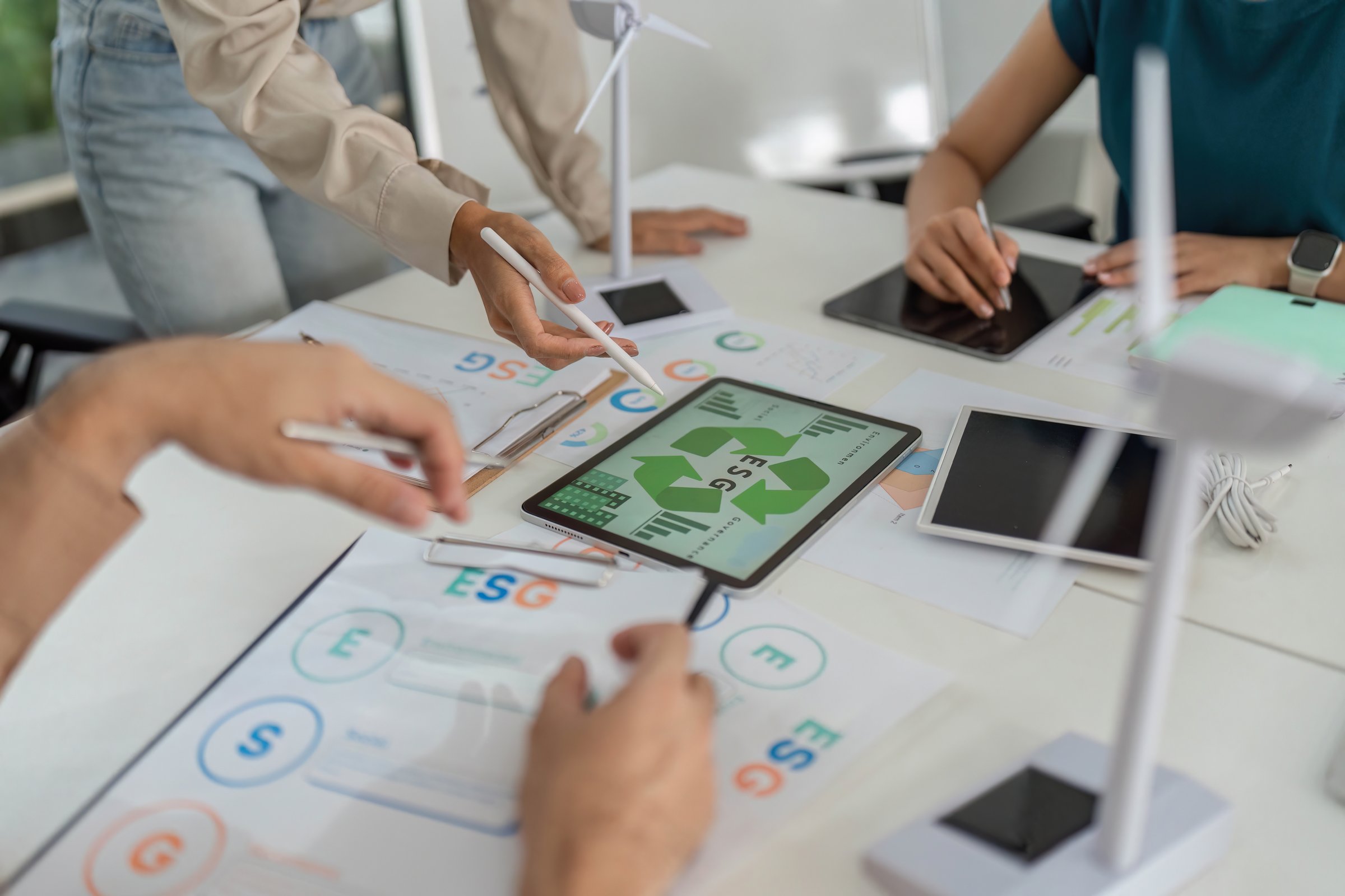 Team members engage in a collaborative planning session, discussing ESG initiatives and showcasing sustainable practices.
