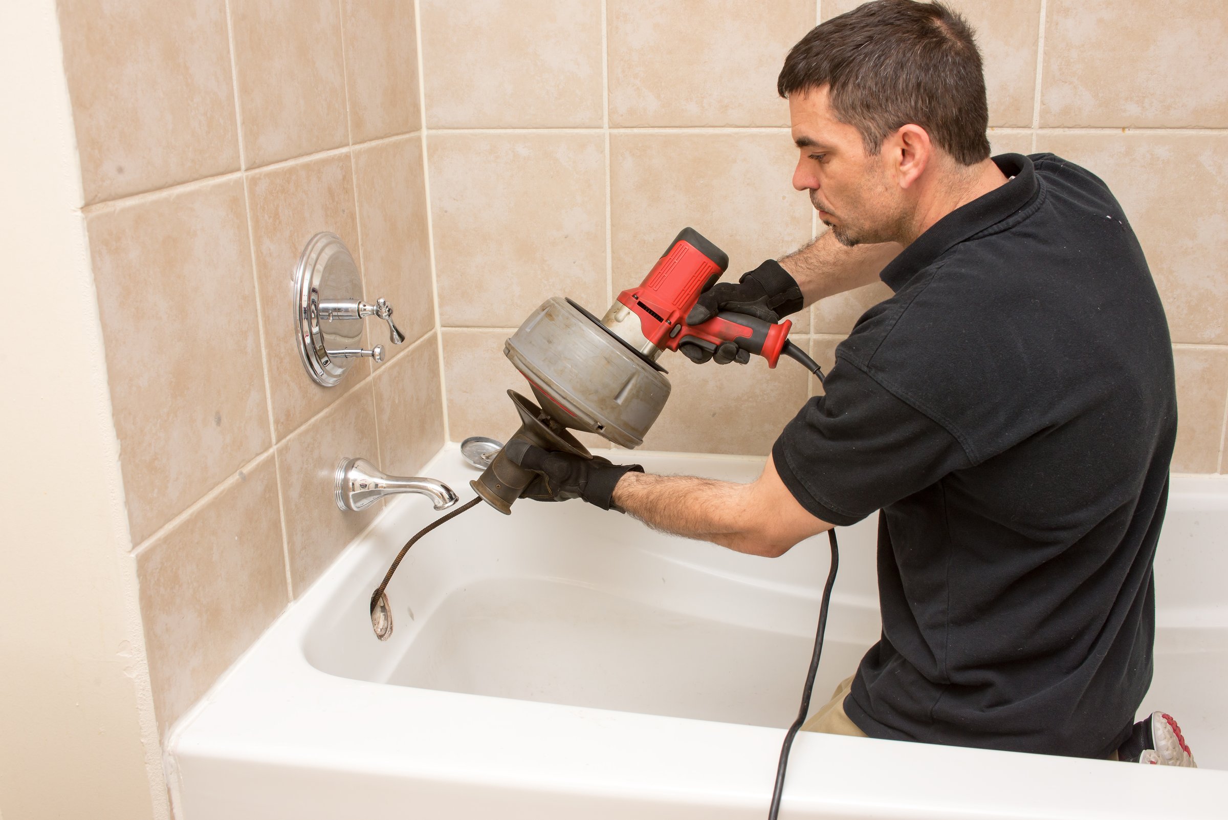 Plumber unclogging a drain