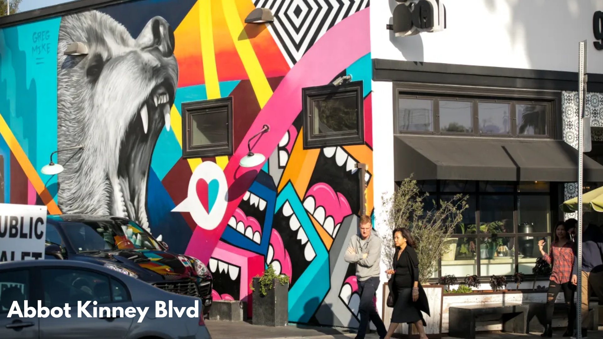 Trendy shops, restaurants, and palm-lined Abbot Kinney Boulevard in Venice Beach, Los Angeles.