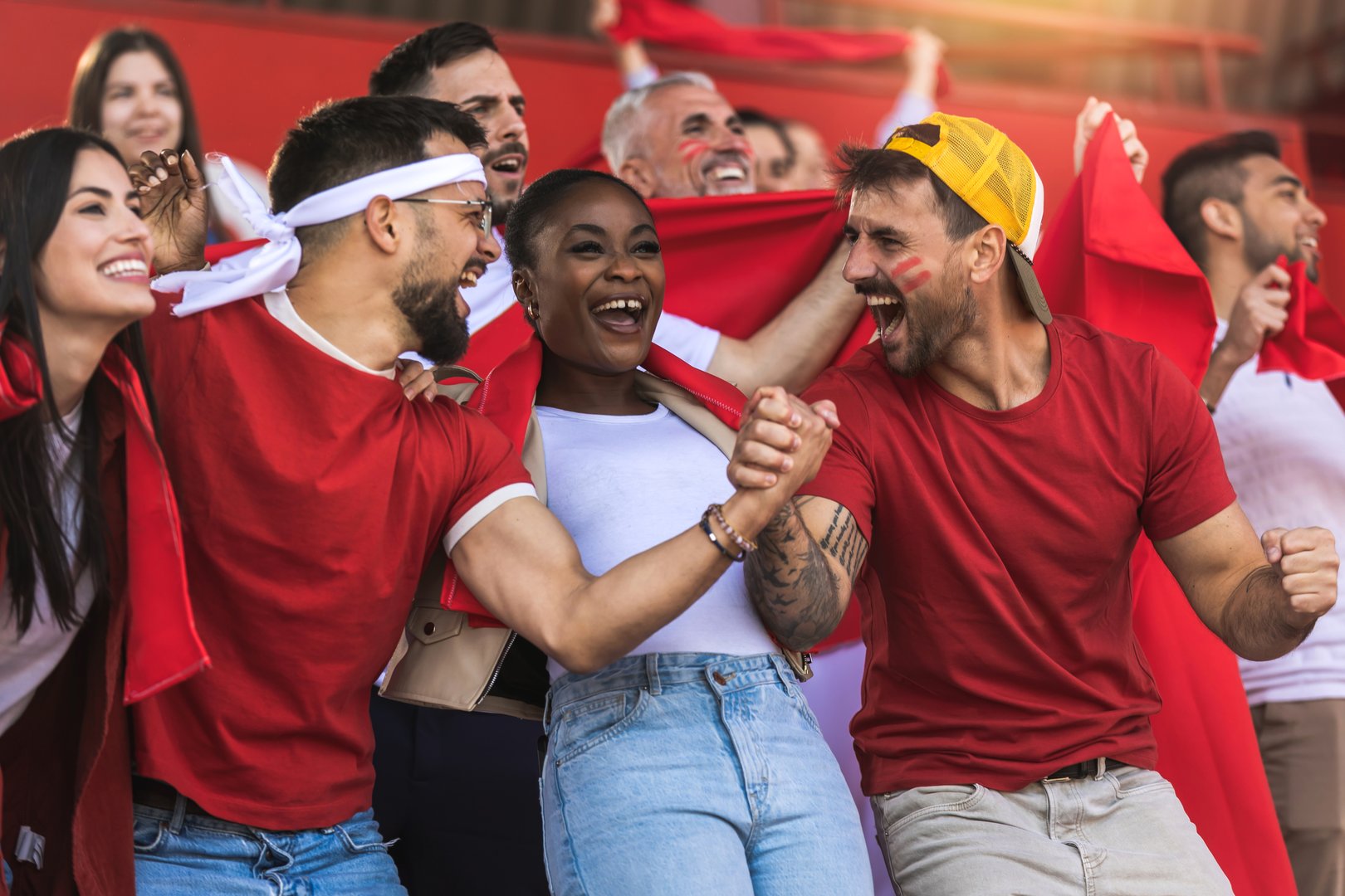 Football / soccer fans are cheering for their team at the stadium on the match