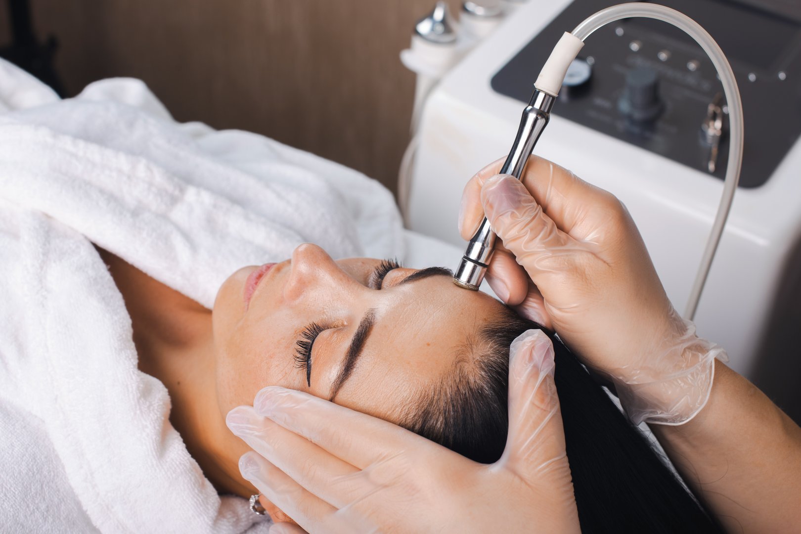 Cosmetologist making cavitation rejuvenation skin treatment