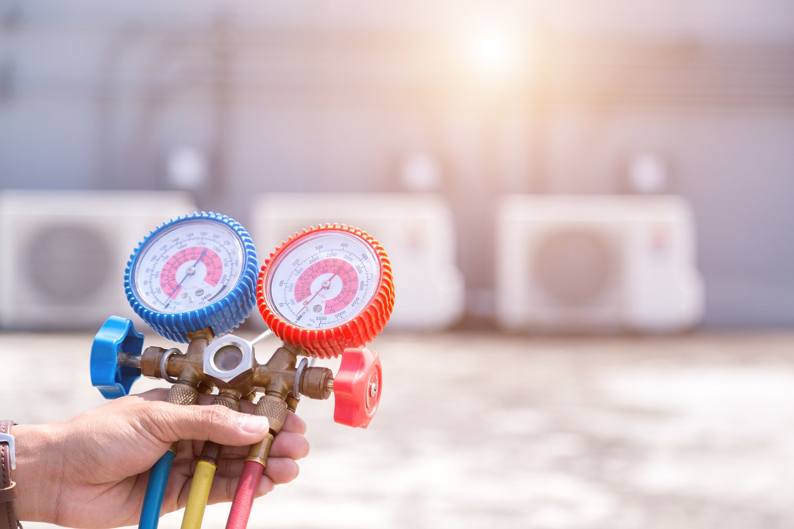 Technician is checking air conditioner ,measuring equipment for filling air conditioners.
